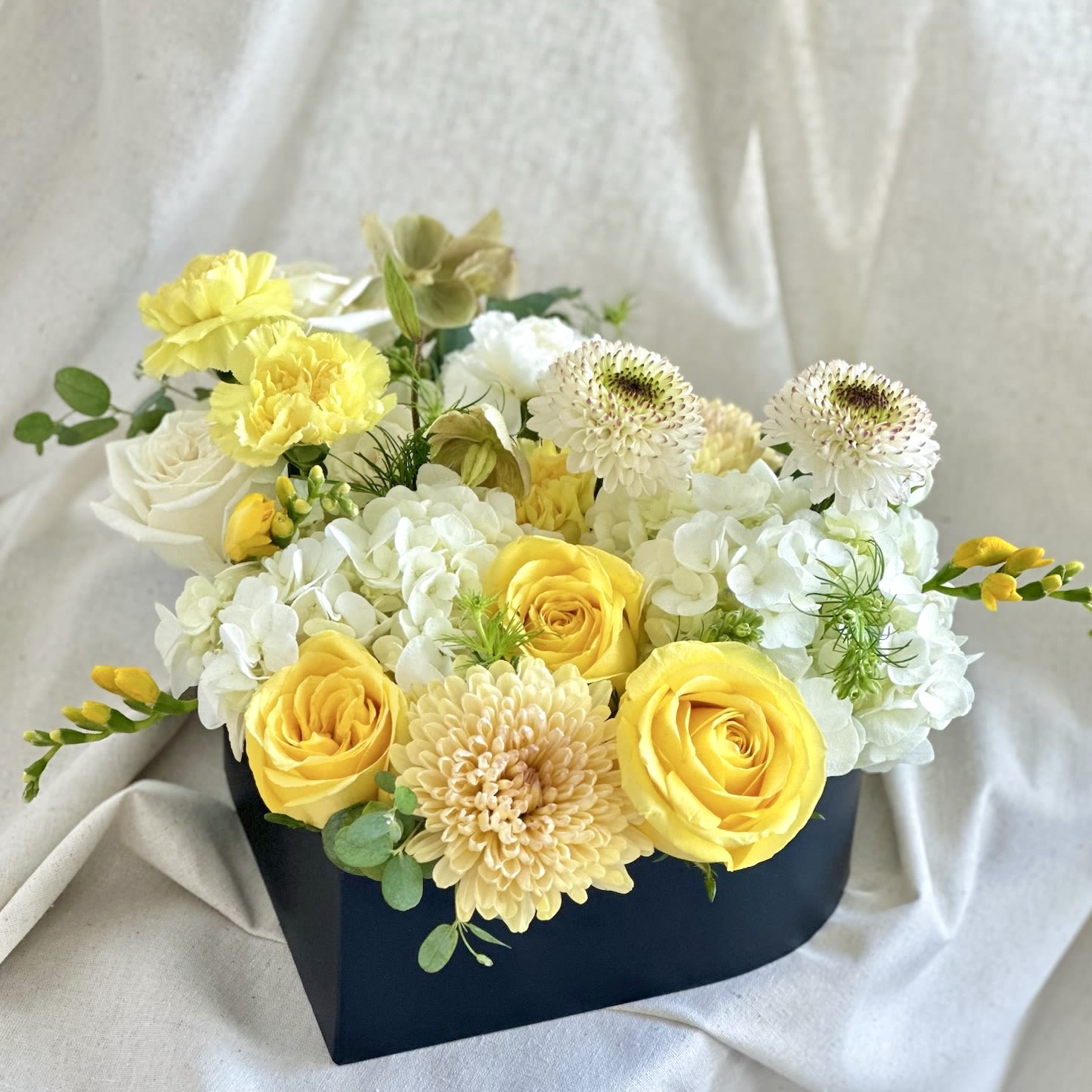 My Love in Yellow  - A heart-shaped box filled with a mix of fresh flowers.   Flower types may vary depending on the season.  