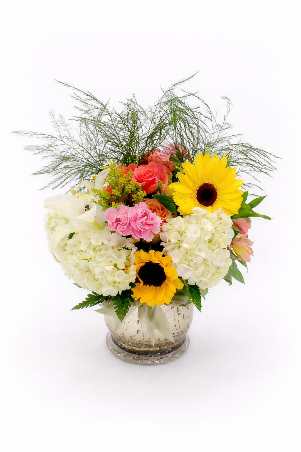 Bright Horizon Vase by K2Y - Bring warmth and elegance to any space with our Bright Horizon bouquet — a radiant blend of sunshine and softness, beautifully arranged in a shimmering mercury-glass vase. This lush design features: premium white hydrangeas, bright yellow gerbera daisies, golden sunflower accents, coral roses, soft carnations, white lilies, fresh seasonal greenery, and airy foliage. The combination of creamy whites, warm yellows, and soft blush tones creates a balanced, joyful arrangement perfect for birthdays, thank-you gifts, get-well wishes, housewarmings, or simply brightening someone’s day.
