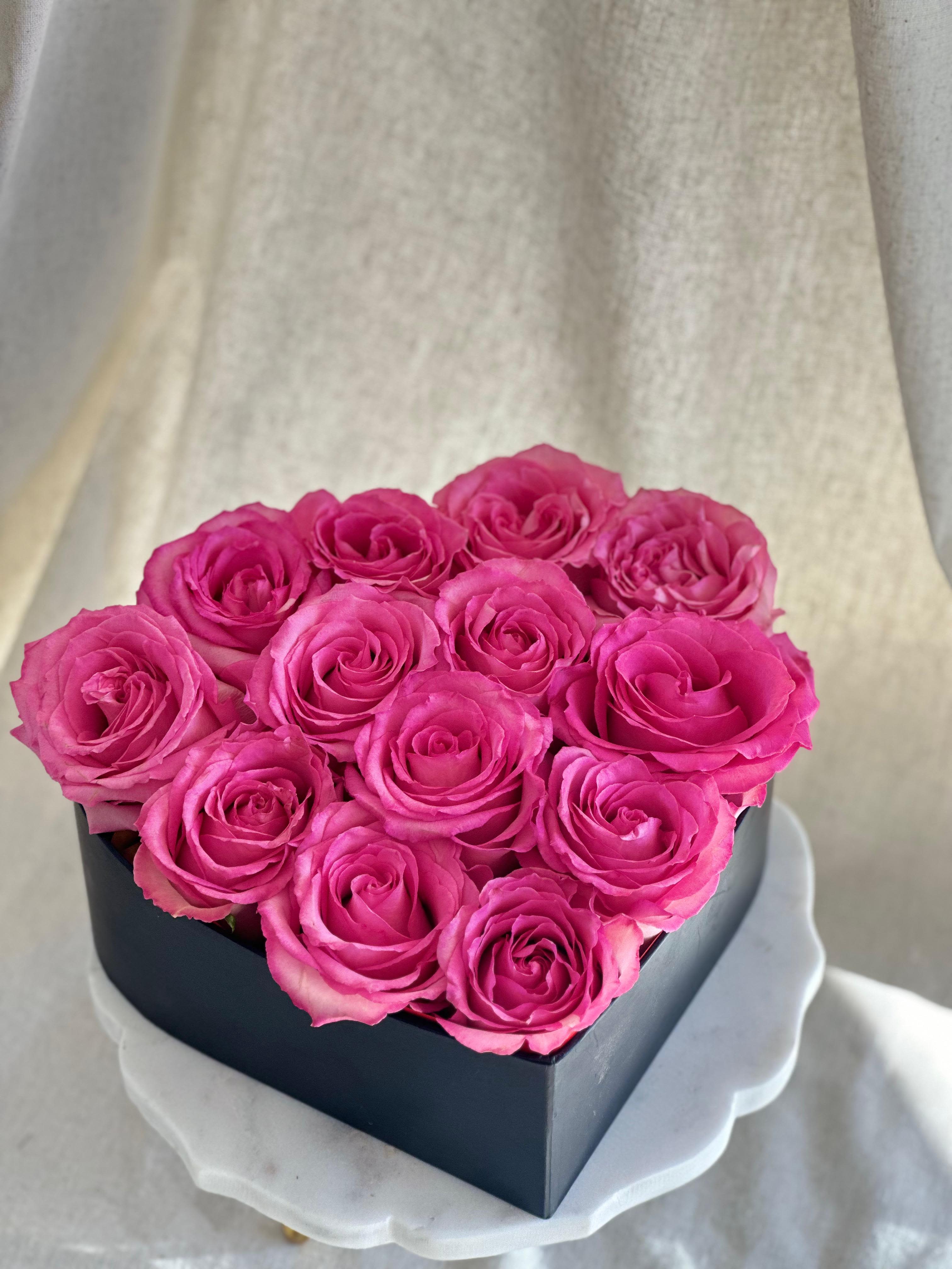 My Heart in Pink  - A black heart-shaped box filled with roses.   Flower types may vary depending on the season.