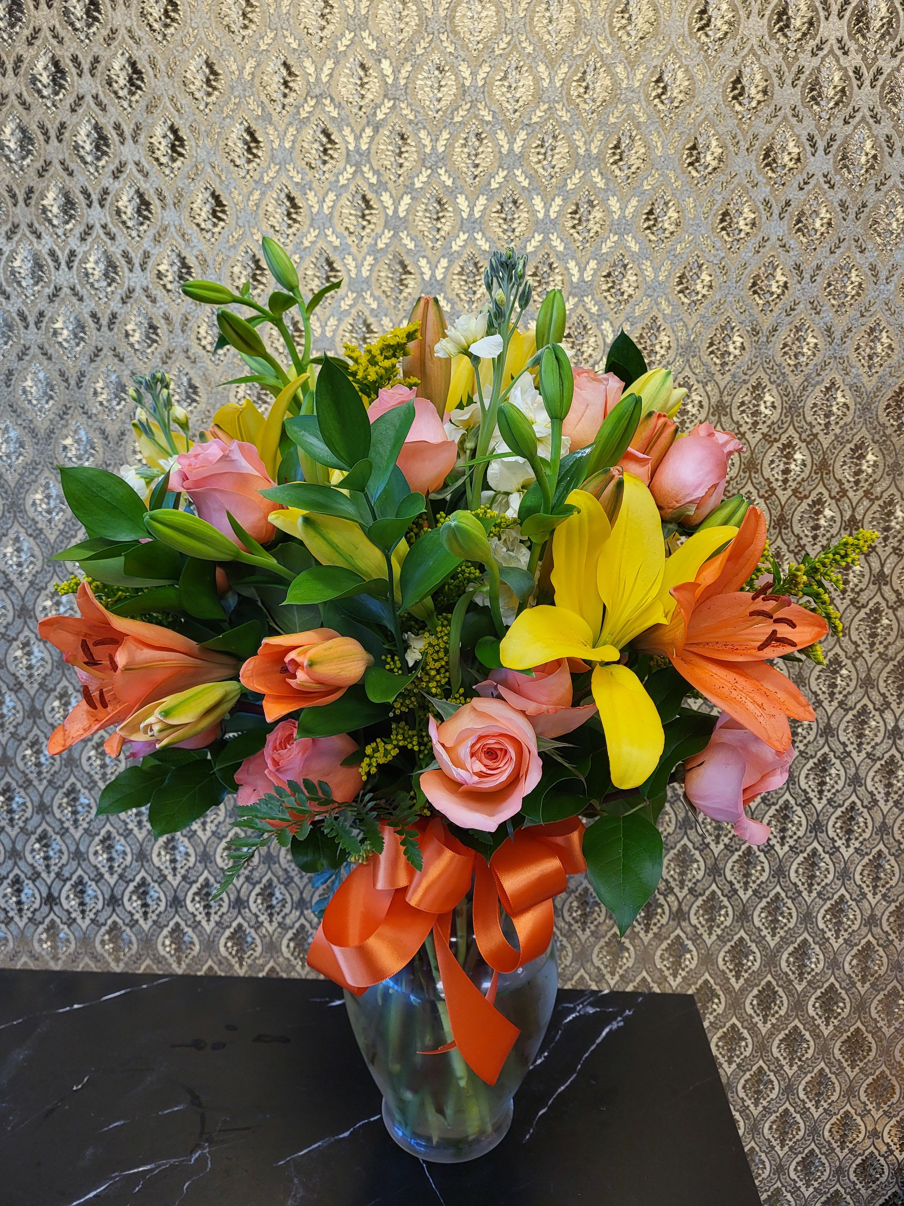 Designer's choice special!! - Ellie flowers exclusive, designer choice in a clear vase.  Pictures for reference only.  Includes a golden/birthday card and envelope. please specify card message on instructions.  Standard: one dozen assorted roses with mix flowers Deluxe: two dozen assorted roses with mix flowers Premium: three dozes assorted roses with mix flowers