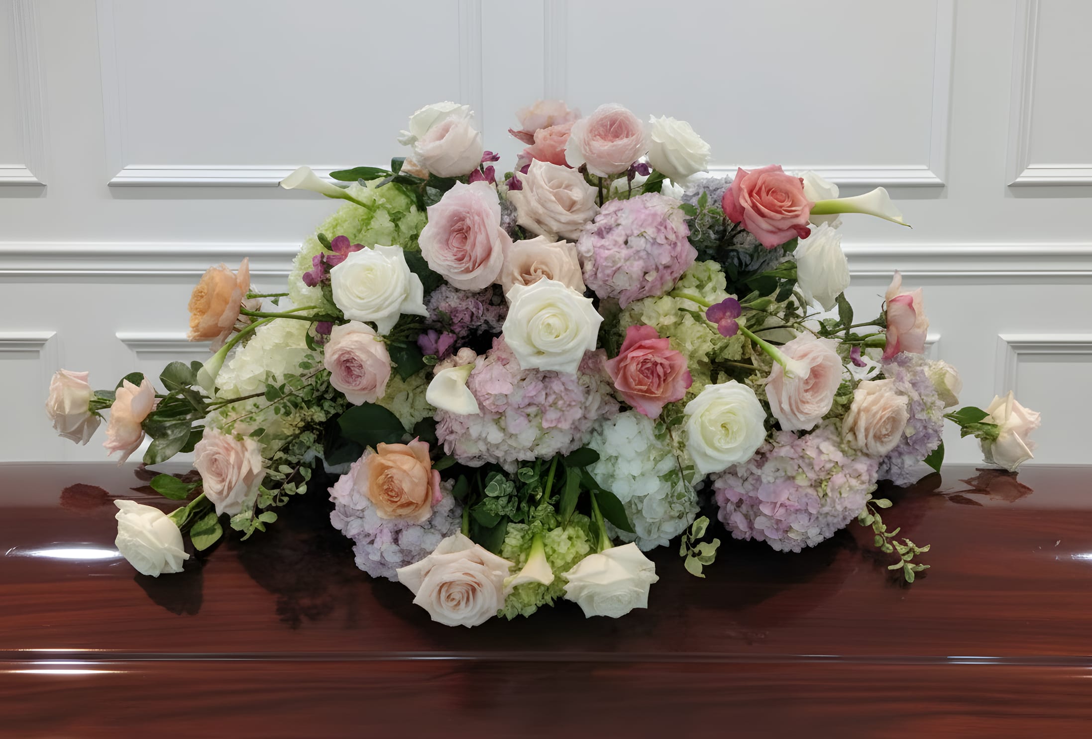 Tranquility Casket Cover - Lush casket cover in shades of pinks and lavender and white, accented with assorted foliage.