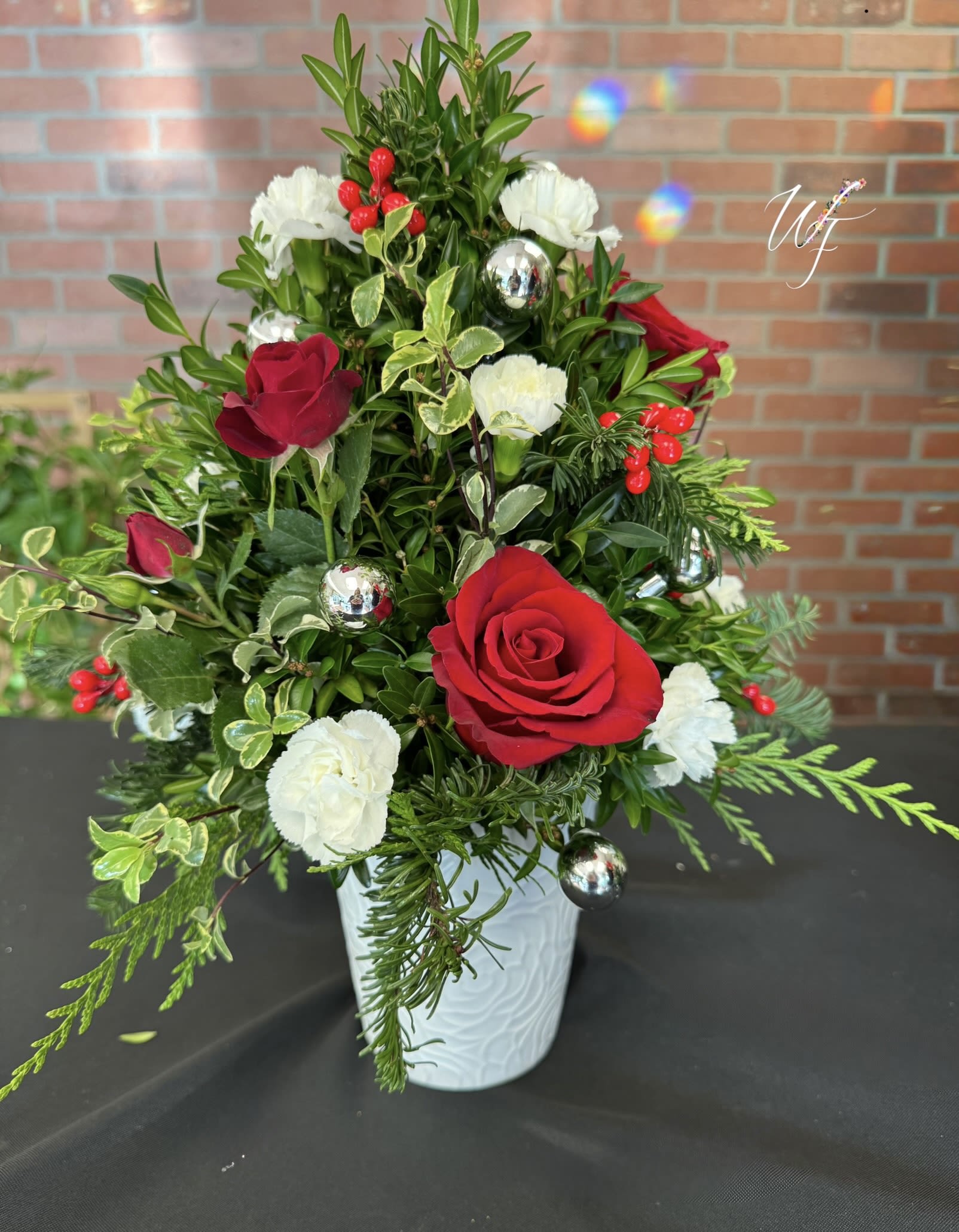 Tree top Magic  - This beautiful tree is made of different winter greens, accented with white and red blooms