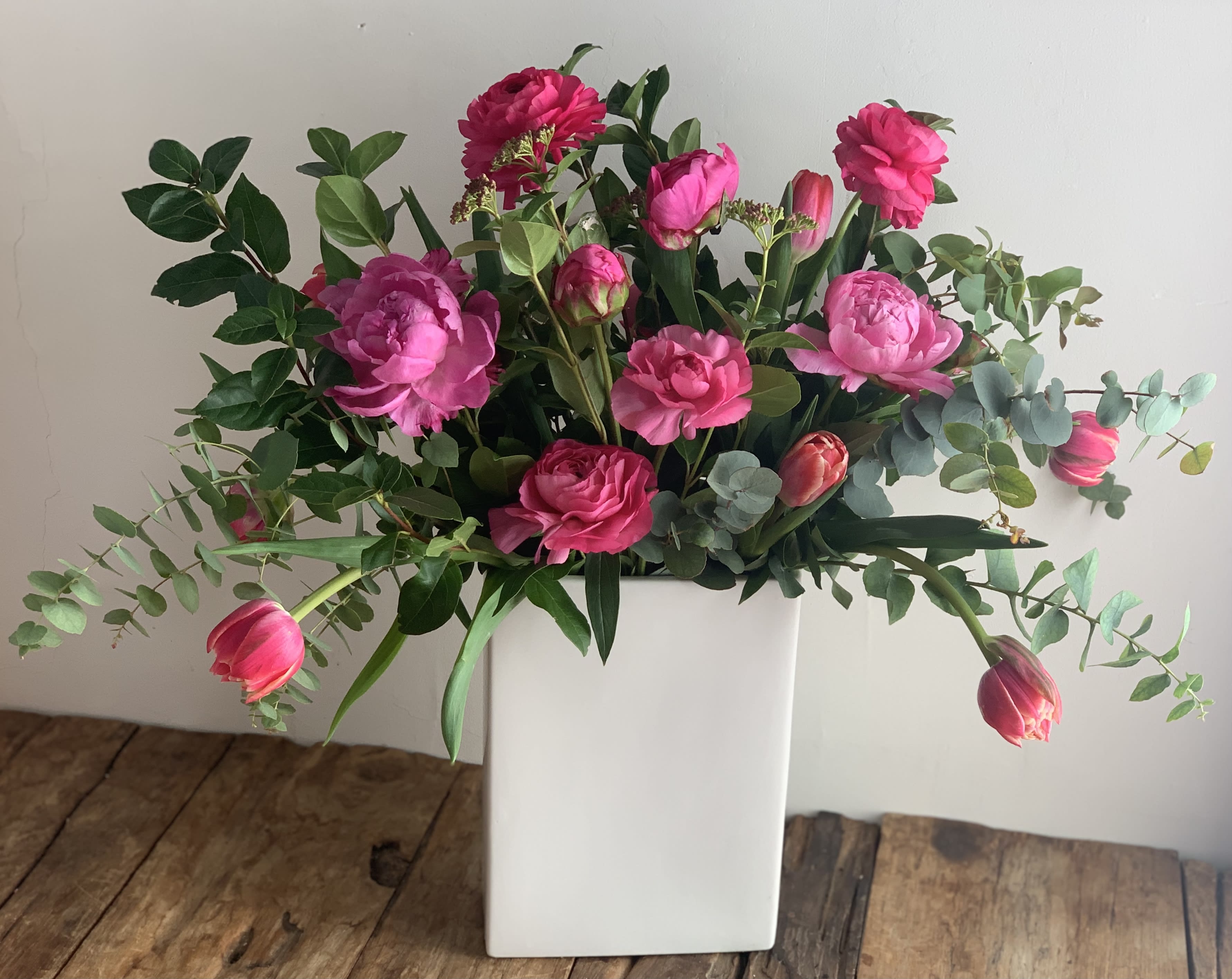 Pretty in Pink - Gorgeous mix of pink garden rose (peony are seasonal) , tulips, ranuculas &amp; loose organic greenery in a tall white modern ceramic vase.