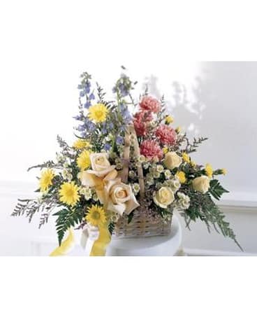 Loving Remembrance Basket - Ivory and soft peach Roses pink Carnations and blue Belladonna are accented with yellow blossoms. Accented with Sprigs of Green this basket arrangement conveys your deepest sympathies.   FCS32-3169