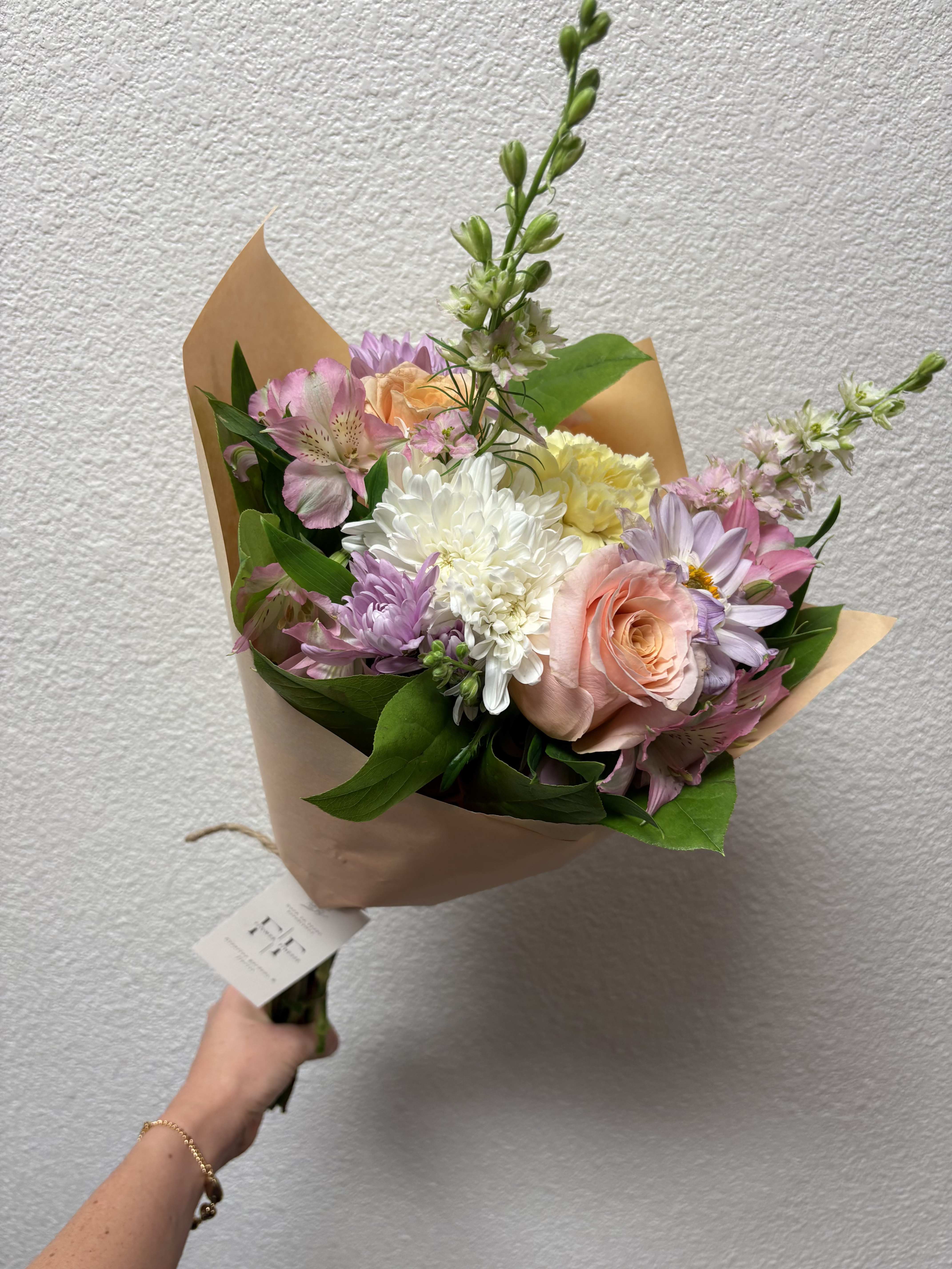 Local offer- Signature Wraps - Our signature wraps includes our best, seasonal standard flowers designed and wrapped in paper and ribbon. Just add occasion during check out! :) Available for pick-up in-store only.  (See hand-held bouquet for $45 value or more bouquet available for delivery)