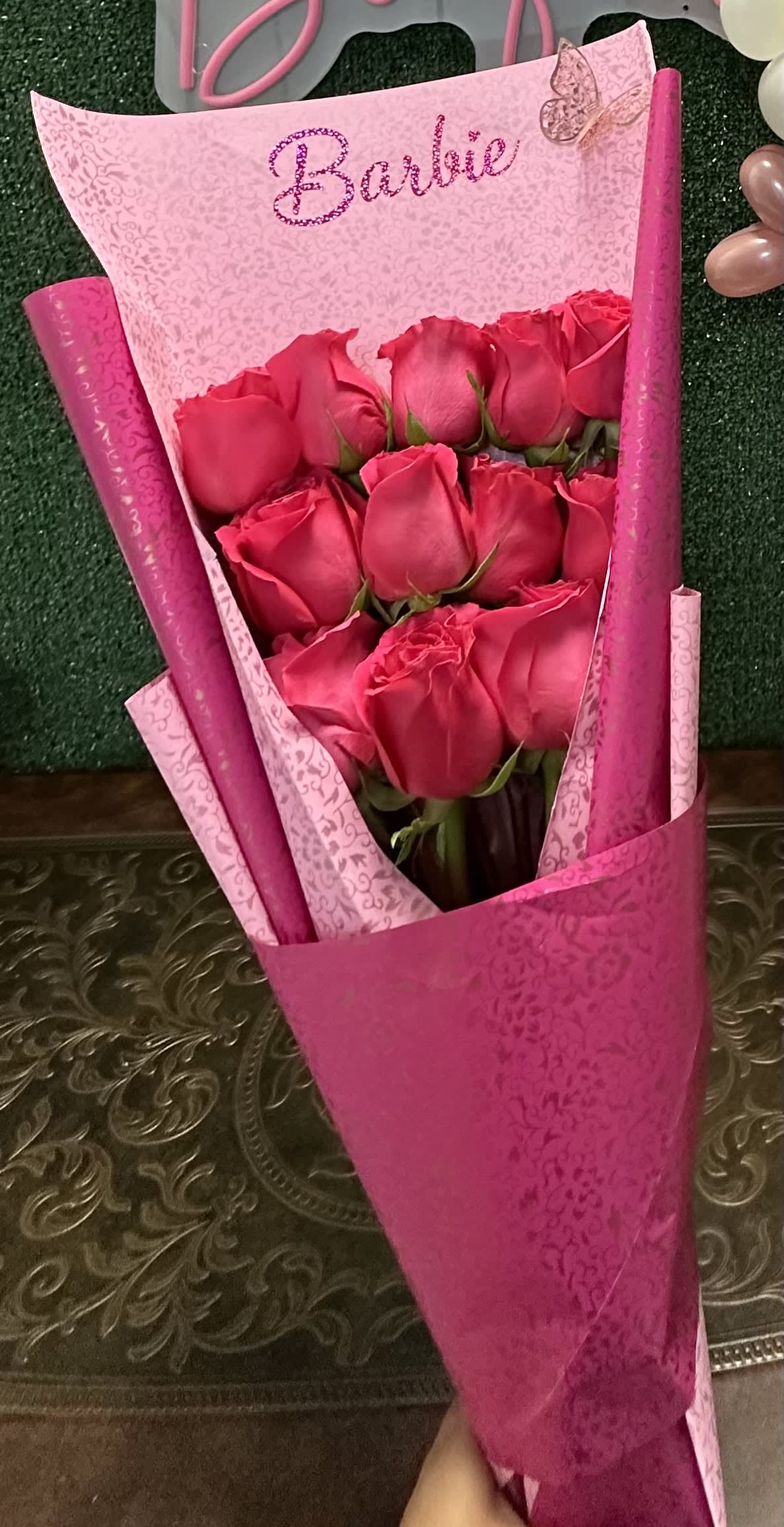 Barbie hand bouquet - Fresh roses on pink and hot pink wrapping paper  Standard 12 roses Deluxe 18 Roses Premium 24 Roses "Picture is a reference every arrangement would not be exactly the same. Flowers and color substitution may apply"