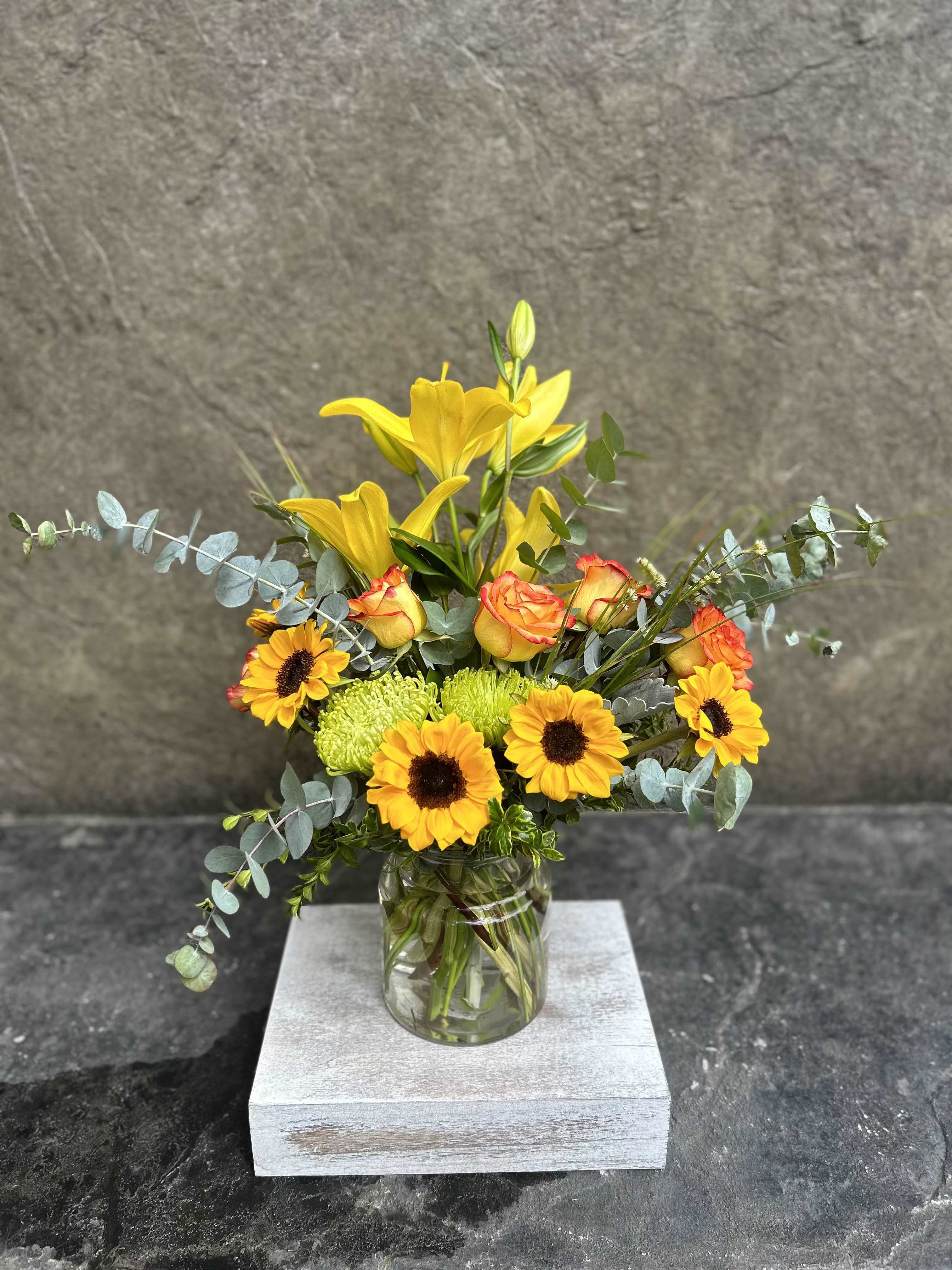 Good Day - Bright cheerful blooms, sunflowers, roses and Lillies with fragrant eucalyptus, and grasses. 