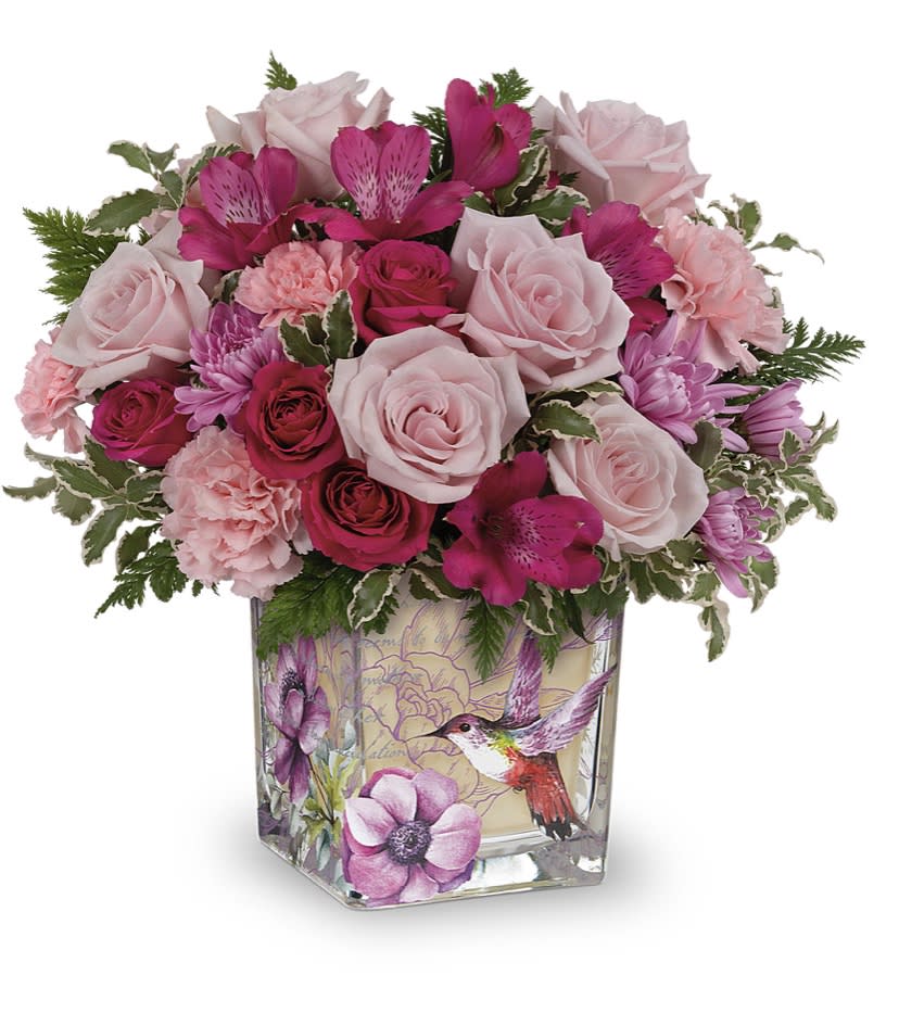 Sweet Hummingbird  (T) - Like a hummingbird floating around a secret garden, this delightful bouquet of pink roses in a vintage inspired glass cube is a magical gift on Mother’s Day or any special occasion.   Please note: the bouquet pictured reflects our original design for this product. While we always try to follow the color palette, we may replace Stan’s to deliver the freshest bouquet possible, and we may sometimes need to use a different vase.