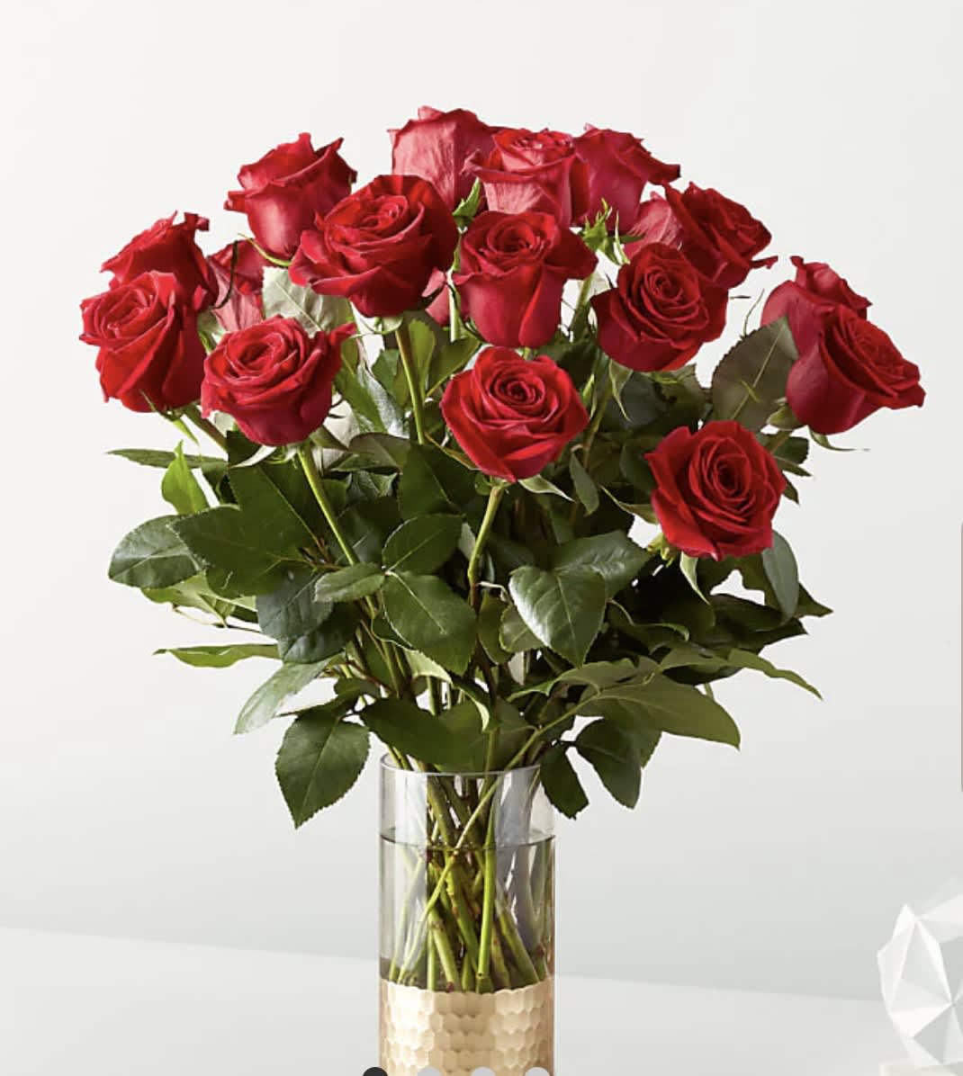 Classic Love Red Rose Arrangement (F) 18 stems or 24 stems - The Classic Love Red Rose Bouquet is love's most timeless flower. Nothing conveys romance quite like this bunch of red roses, the most iconic expression of heartfelt emotion and passion.  Please Note: The bouquet pictured reflects our original design for this product. While we always try to follow the color palette, we may replace stems to deliver the freshest bouquet possible, and we may sometimes need to use a different vase. 