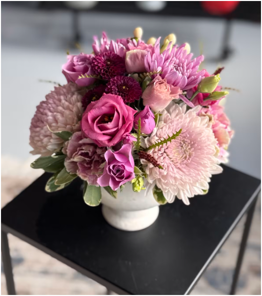 Moss &amp; Fauna  - Moss &amp; Fauna is a low, compact floral composition designed to feel lush, layered, and artfully grounded.  Full of movement and texture, this arrangement features premium blooms in a thoughtfully curated seasonal palette that evolves monthly. From soft romantic pinks and creamy neutrals to painterly spring tones or richer late-season warmth, each version reflects what’s most beautiful right now.  Designed in a modern low vessel, Moss &amp; Fauna is perfect for coffee tables, kitchen islands, dining spaces, and entry consoles. It’s full from every angle — intentional, textural, and elevated without feeling fussy.  Each design is florist’s choice within our current seasonal color story, ensuring the freshest, highest-quality blooms available. Although we cannot guarantee specific colors, you can always put your request in the notes box.  Compact in size. Abundant in presence.