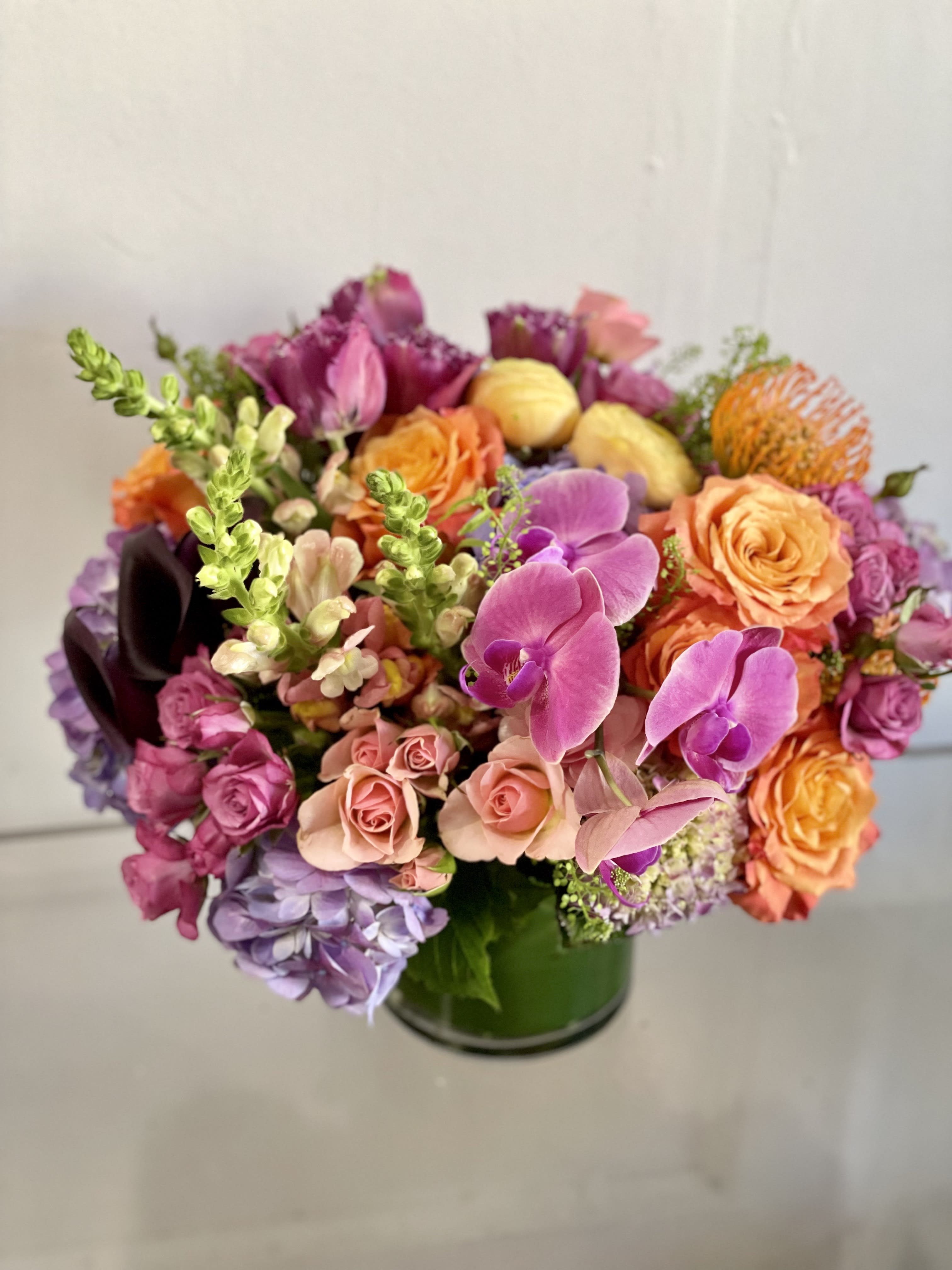 BIG LOVE YOU ENERGY - This is a big lush arrangement that takes a statement. Not for the faint of heart, this arrangement packs a premium punch of bright florals. Large and lush premium bloom for a coffee table or dinner table. DESIGNERS CHOICE IN THIS PALETTE. 