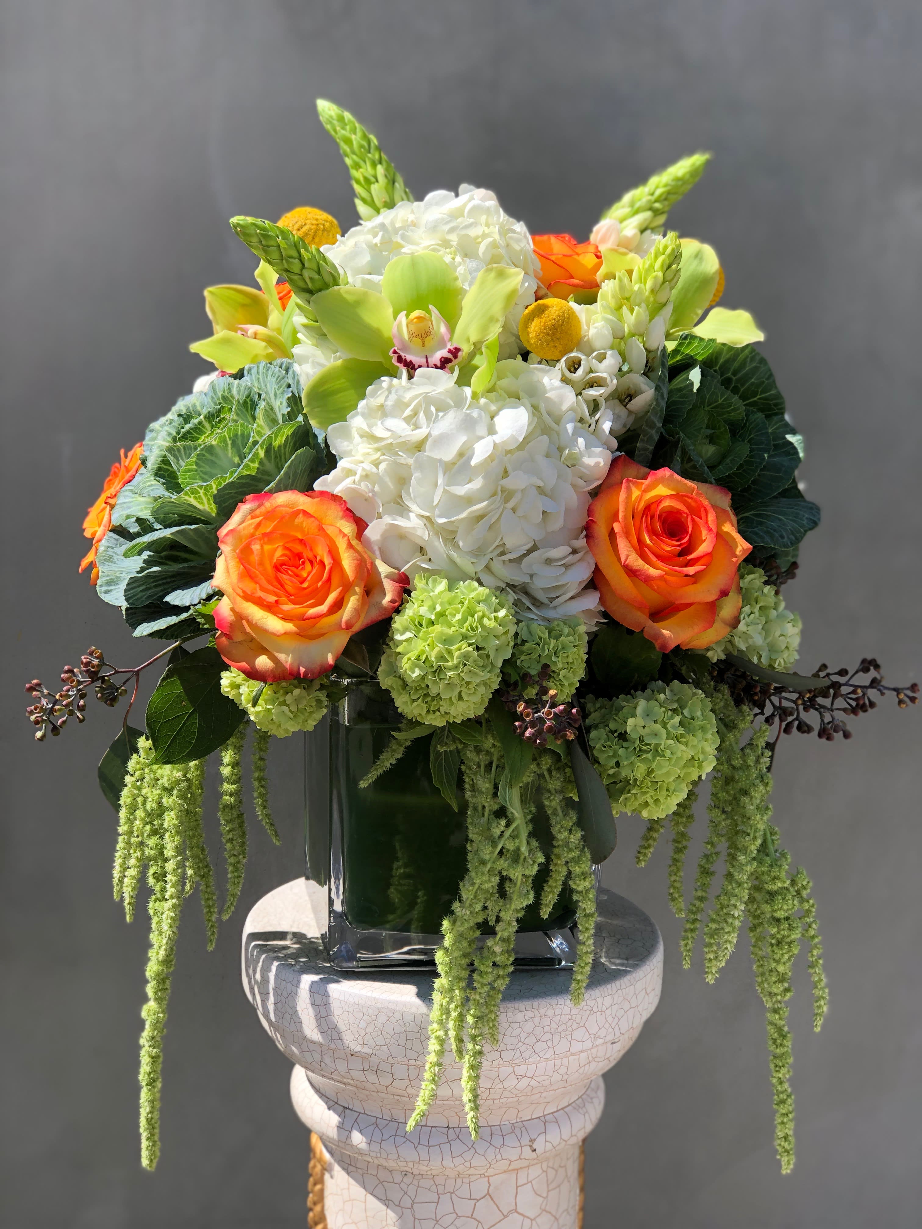 Just for spring - This spring arrangement includes, roses, hydrangea, flowering cabbage and other seasonal flowers in this color pallet that are the freshest in our shop the day of delivery. 