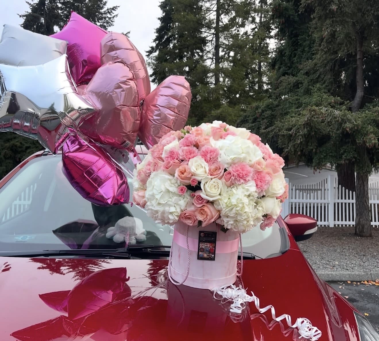 Pink Girly Box  - Girly box is filled with designers choice of an array of fresh cut pink shades of flowers such as, Roses , Hydrangeas, carnations  spray roses and more. Topped with a bow. (Florals placed in wet foam infused with floral food preservative to extend life of flowers. box color and style vary.)