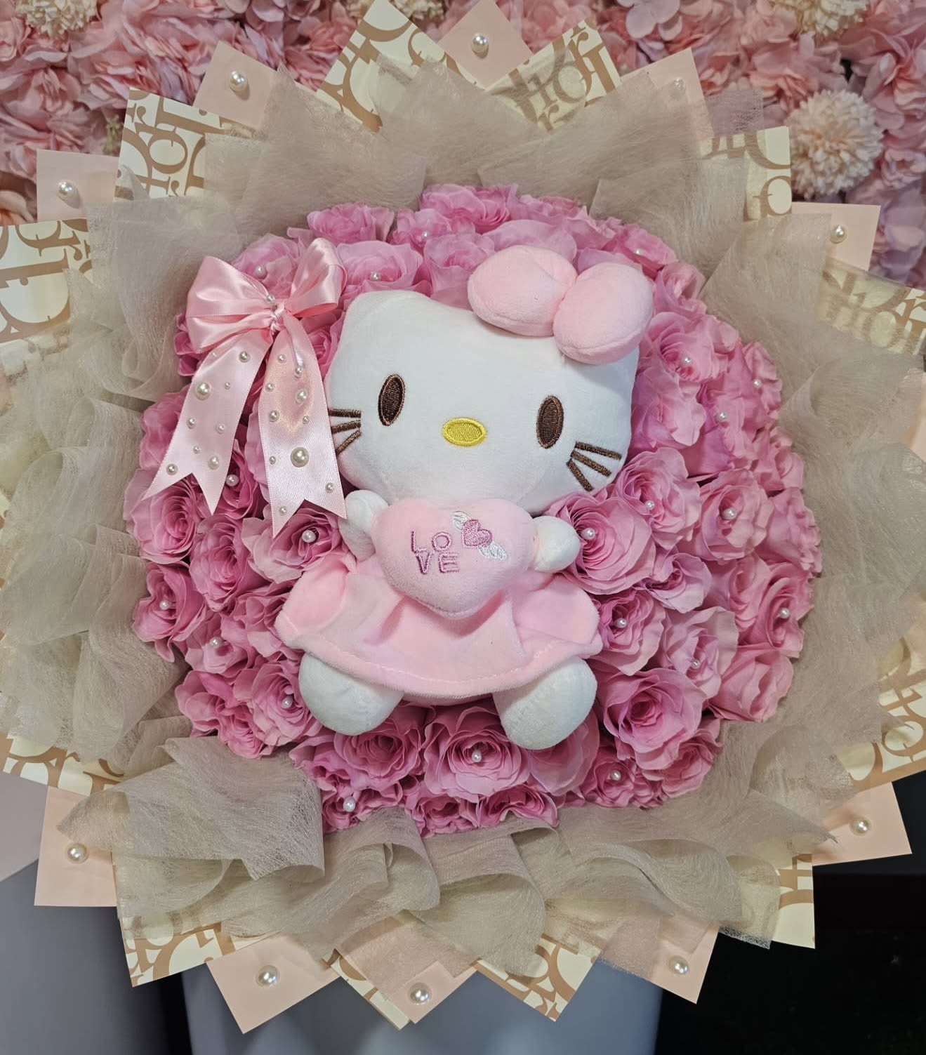 Pink Kitty Lover Bouquet  - This is all you need to make that special person fall in love. Surprise she or he with an elegant all pink roses bouquet. Our hand-tied bouquets are delicately arranged combining pure Ecuadorian roses. You can choose from 50 - 100 (or more).   includes  50 to 100 roses depending on selected size  Hello kitty Plushie Pink bow Tissue wrapping  Topped with pearls on the wrapping paper.