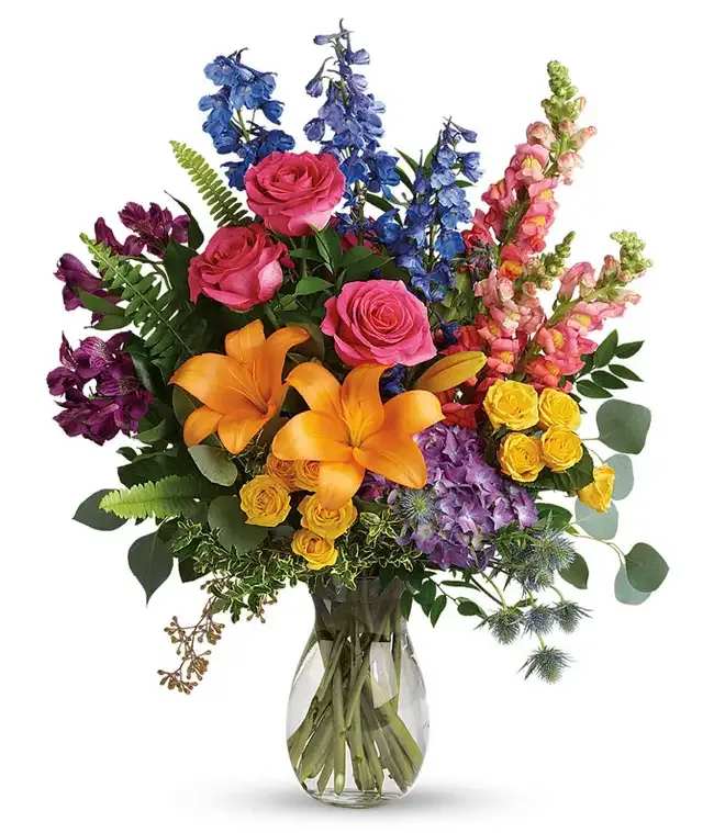 Rainbow Floral Celebration  - This lovely bouquet holds all of the colors of the rainbow, perfect for any occasion. Brilliant and bold, this artful arrangement will put a smile on their face. St Petersburg's top choice. Local Floral Delivery. Flowers may vary do to availability