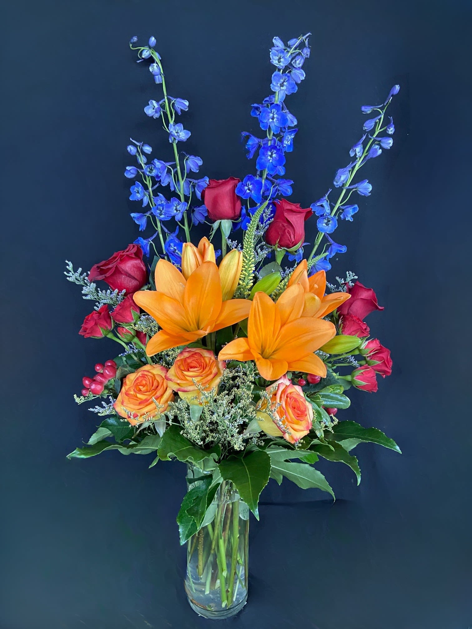 Ravishing Rainbow - A full rainbow of colors in this arrangement makes it a perfect arrangement to send to brighten up any space. A tall vase and height-defying flowers make it a great option for lifting someone's spirits.