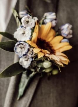 Sunflower Boutinerre by Love and Bloom - The other half to the sunflower corsage! This bout is the perfect pairing that brings a bright contrast to a stark background!   *Please specify ribbon color, dress color, or dress theme in the order details*