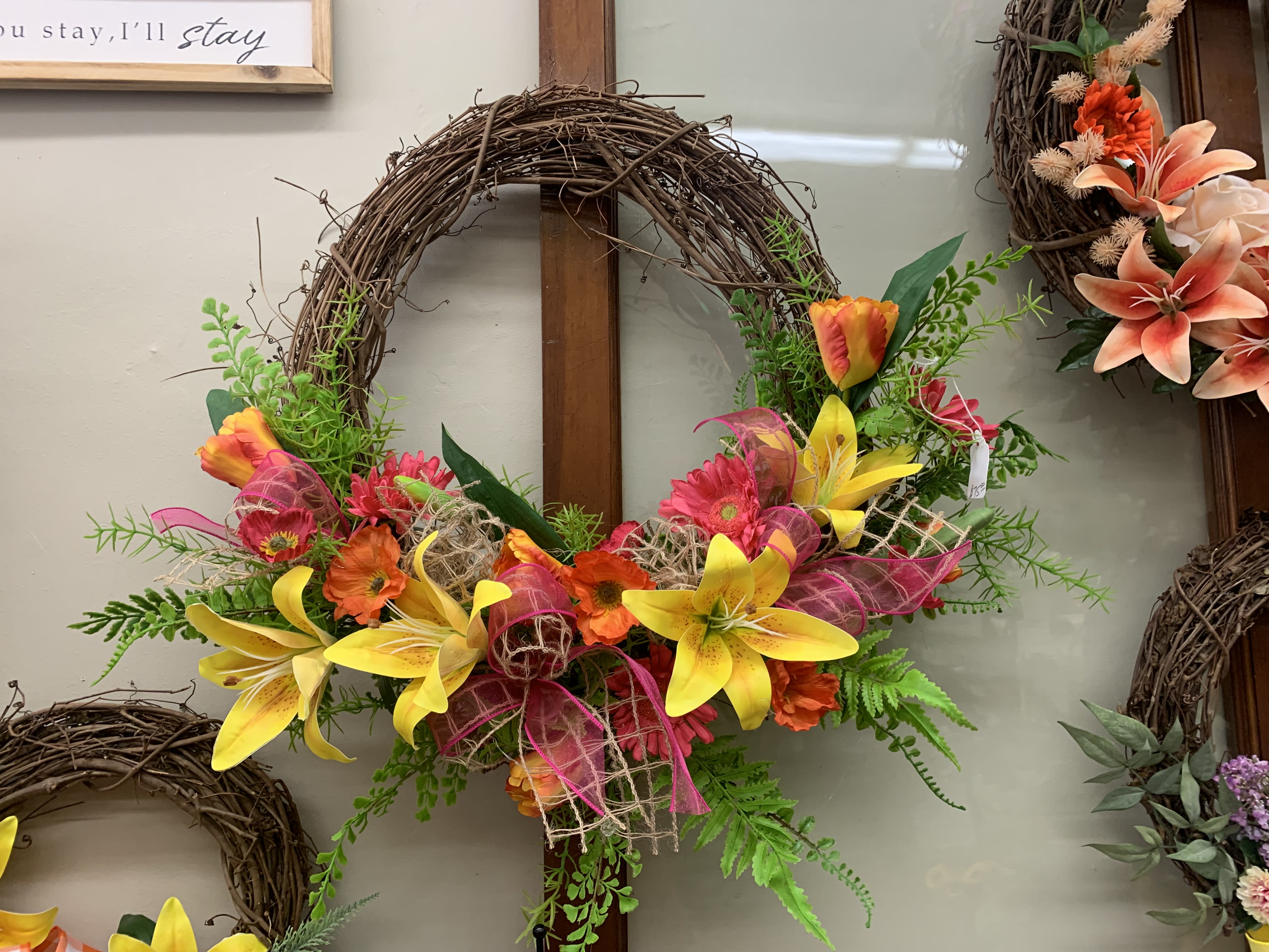 Vivid Wreath - Bright mix of artificial pinks, oranges, and yellows on a grapevine wreath. This product is made from ARTIFICIAL flowers.