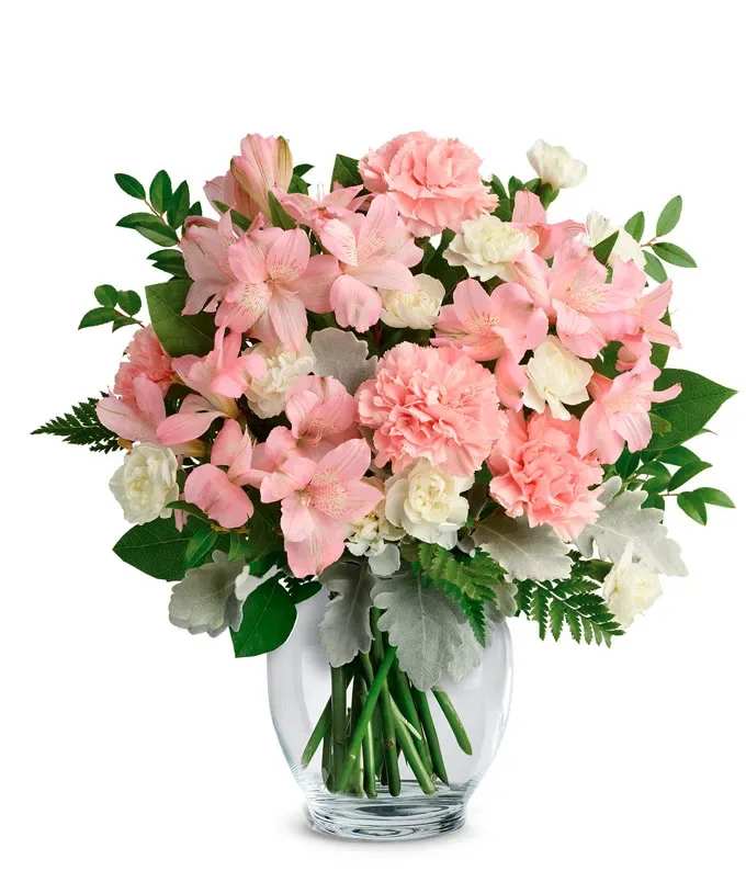 Blushing Pink - Pink and white flowers including alstroemeria, carnations and mini carnations arranged in a vase with mixed greens including dusty miller