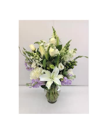 Gentle Surroundings - A beautiful arrangement of mixed white flowers with lavender that gives that perfect gentle touch of color. (Stock, lilies, roses, licianthus, snapdragons, hydrangeas, buttons, hypericum berries )  Flowers and colors may vary depending on availability.    FCF-061