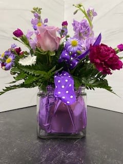 Polka Dot Posey - This cheerful and fun arrangement featuring polka dots is sure to put a smile on her face!  This  arrangement features roses, carnations, stock, and daisies.