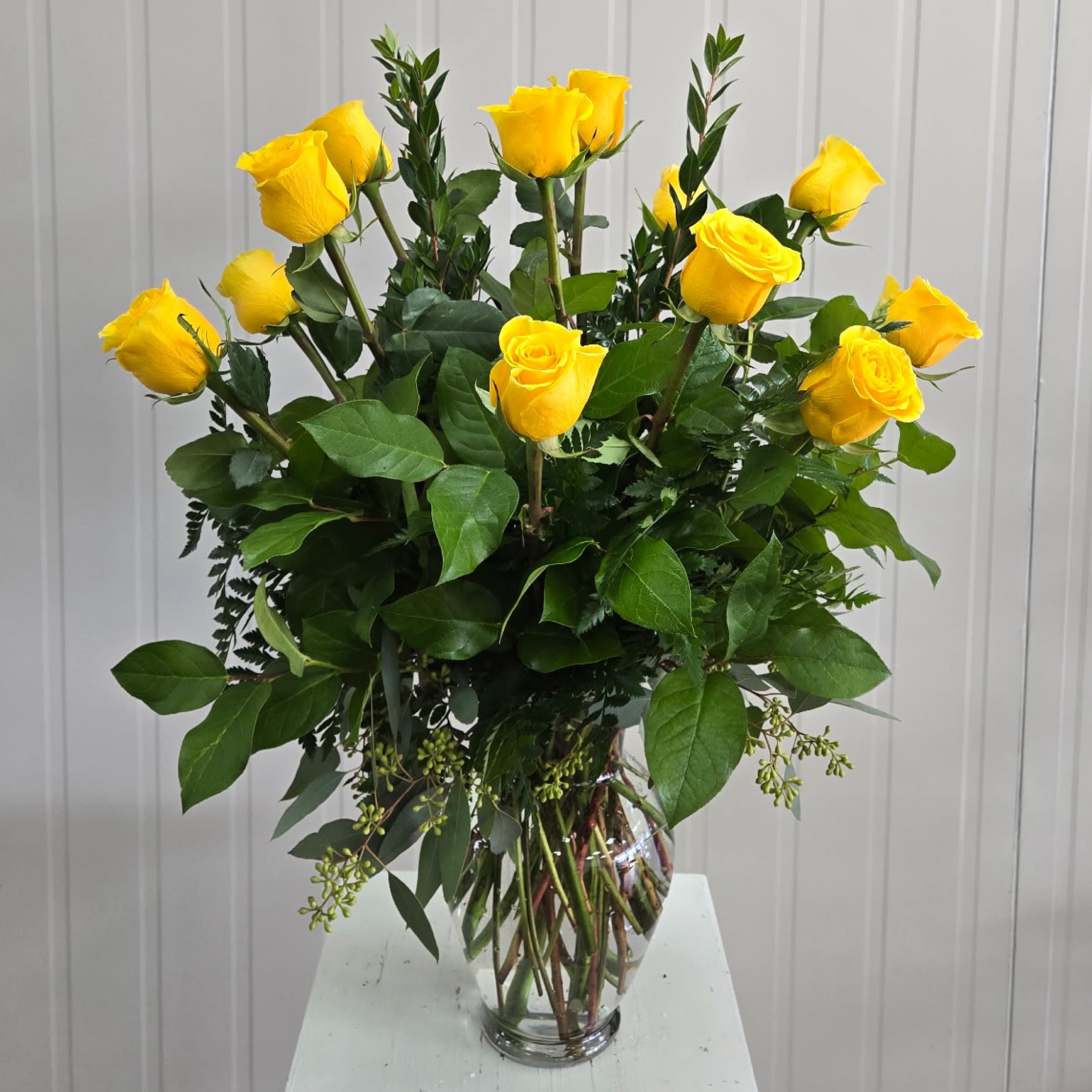 Dozen Yellow Roses - Yellow Dozen Roses and Greenery Arranged in a Glass Vase.