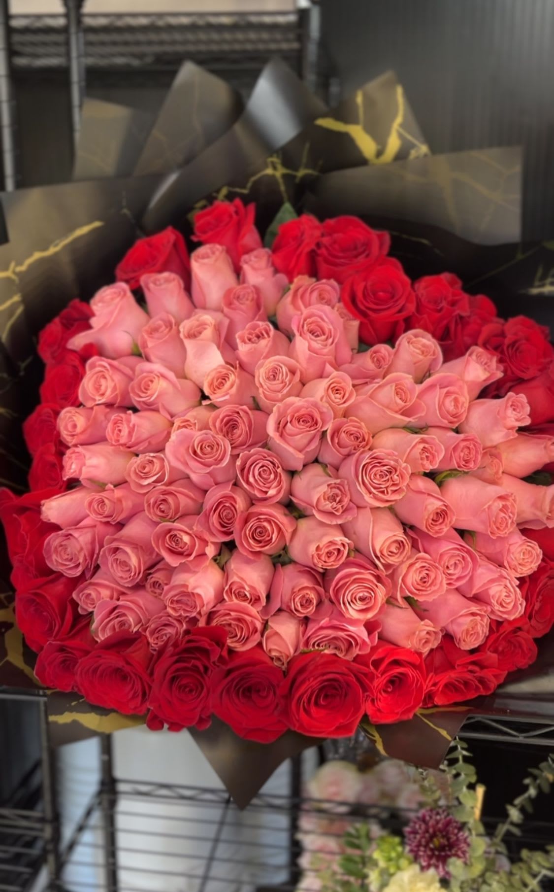 100 roses in a heart shape - averages 100 total roses in a heart shape; a pink center with a red outline