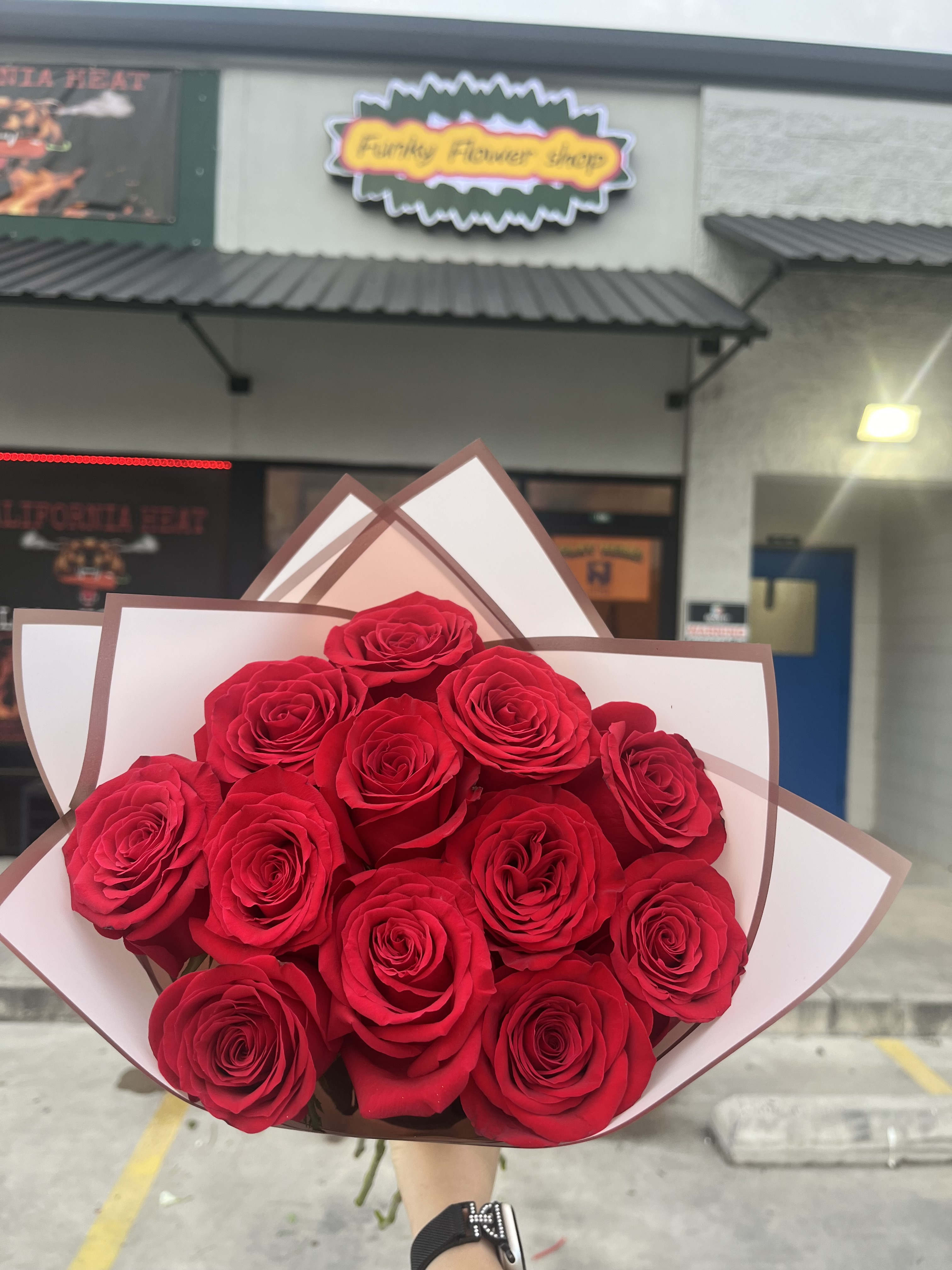 Dozen red roses  - 1 dozen red roses in either a white black or pink sleeve. Choose your color in the commentary or we will choose one for you.