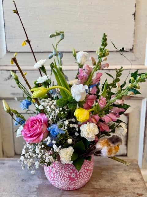 Prelude to Spring - An adorable container holds a fresh spring mix of tulips, snapdragons, flowering branches and is finished off with a bird on a branch. 