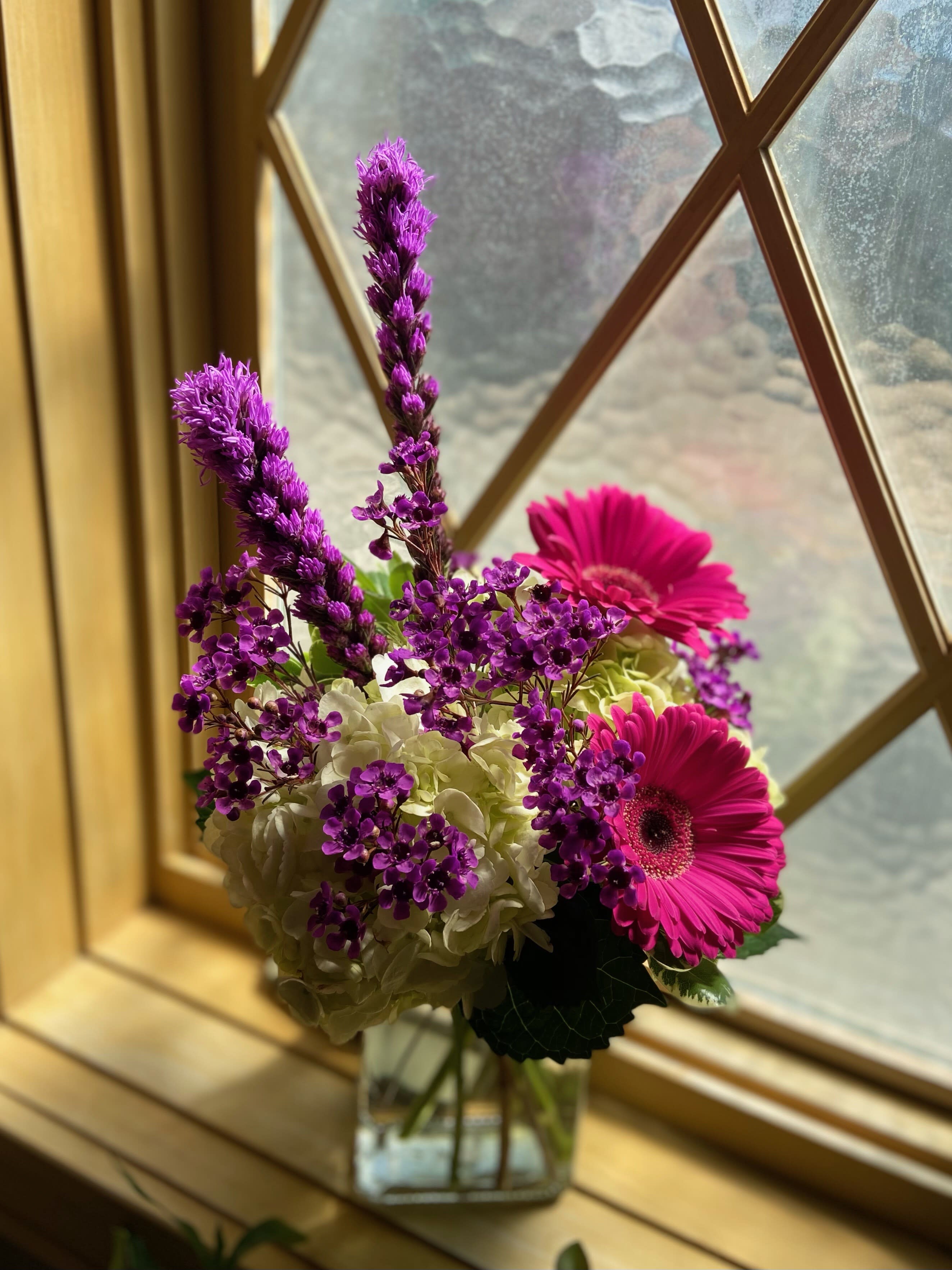 Spring Fling - Hydrangea, gerbera daisies and liatris with accent flowers in a cube vase.