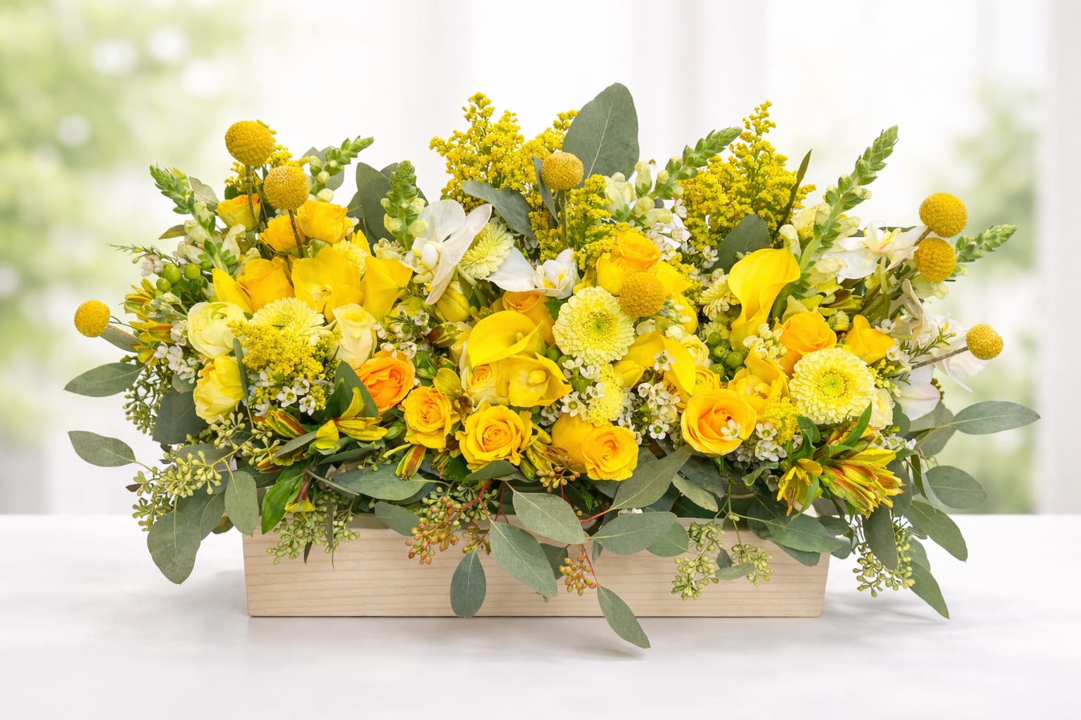 Sunlit Elegance  -  A sophisticated blend of golden roses, sculptural calla lilies, seasonal blooms, and fresh greenery arranged in a modern wooden box. Cheerful yet refined, this design captures the glow of sunlight and the effortless beauty Flowers Of The Valley is known for. 