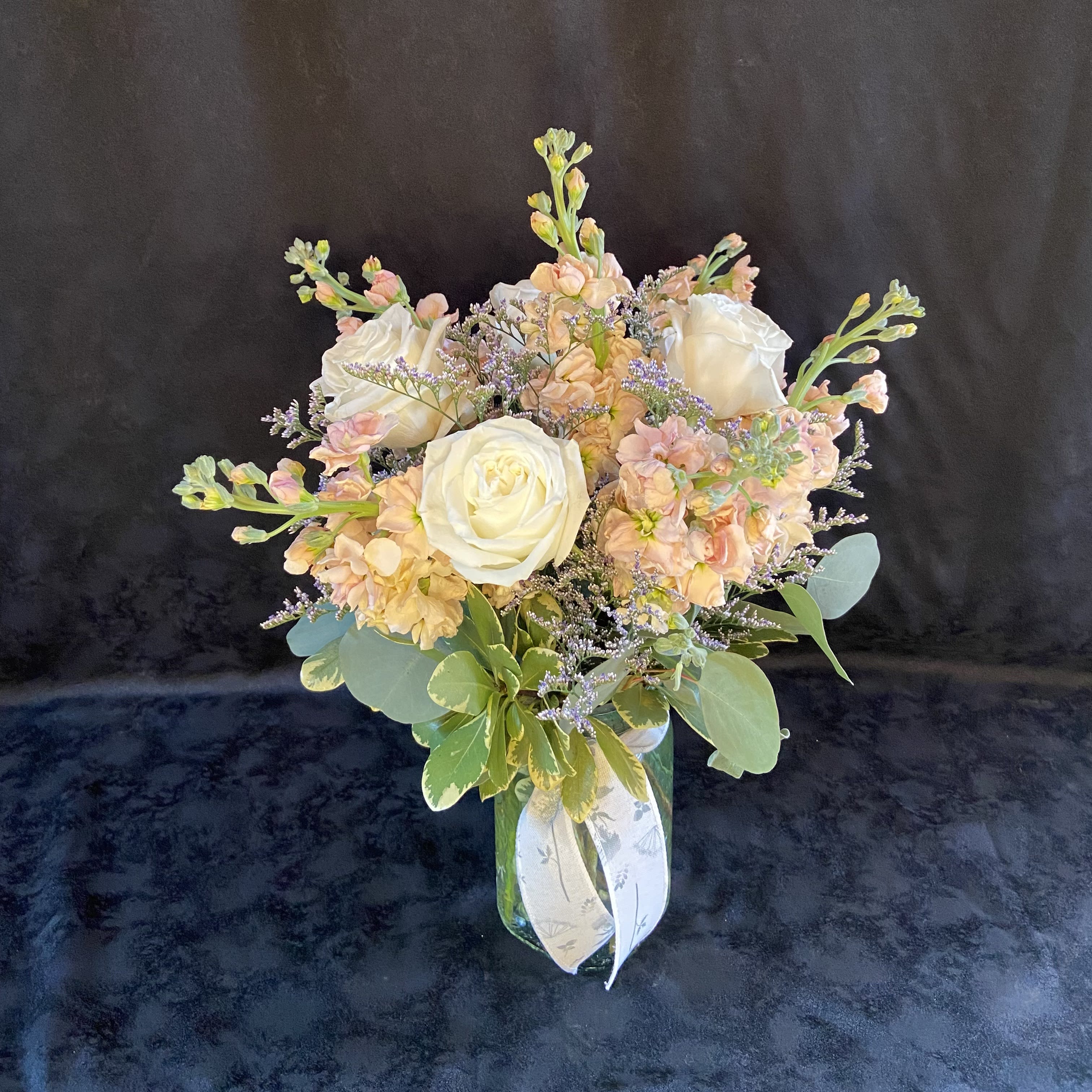 Tickle Me Peach - A mix of white and peach blooms arranged in a vase.