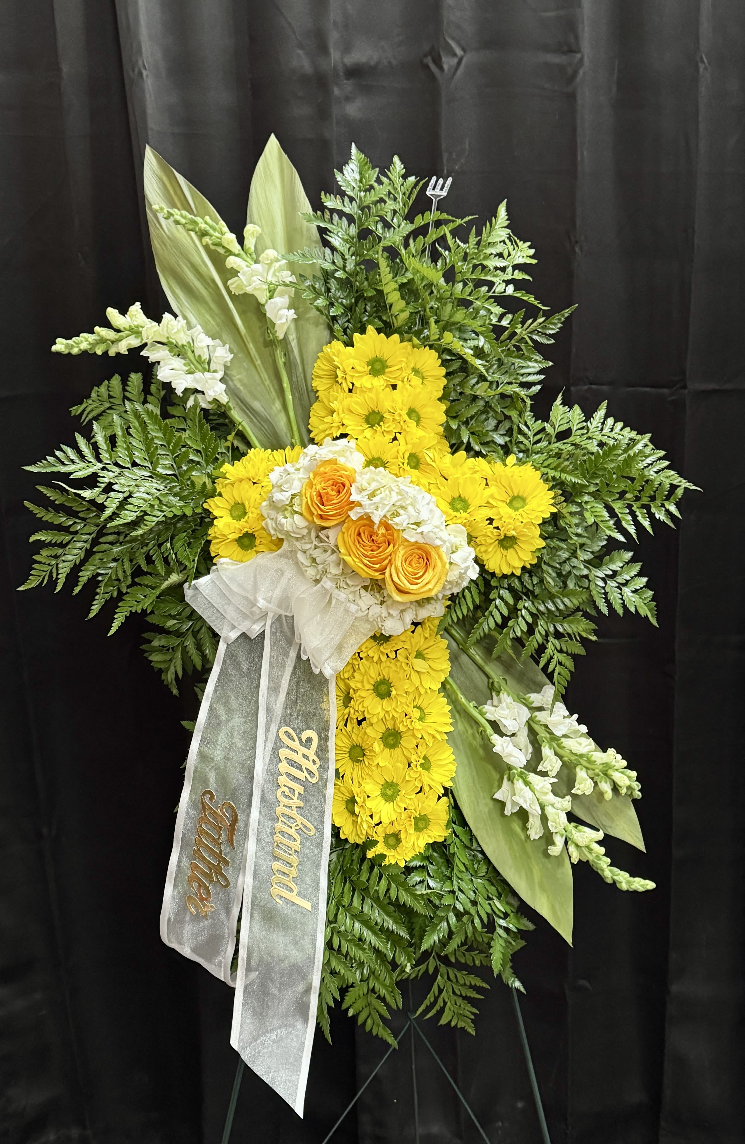 Cross Standing Spray - A cross Standing Spray filled with a color of your choosing. Specific flowers may vary based on availability.