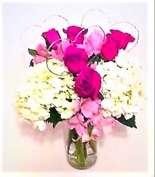Wrapped with Love and Red Roses - One of our most popular designs, created with 6 roses, white hydrangeas, and pink alstromeria in a clear vase with silver hearts for your special someone!