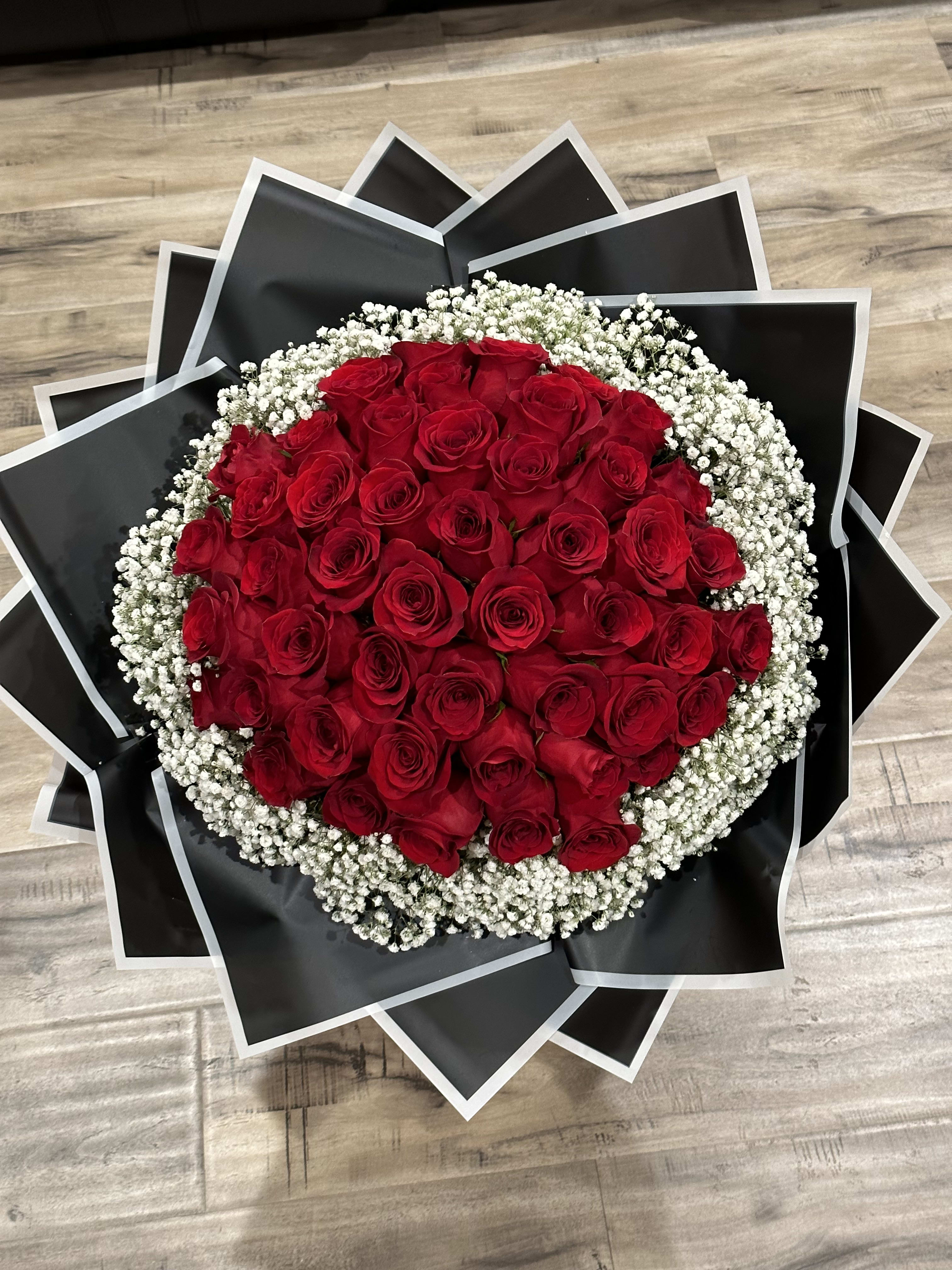 Bouncing White - Surprise your loved ones with 'Bouncing White' bouquet from Yadilynn's Flowers! Overflowing with 50 vibrant red roses and delicate white gypsophila, it's perfect for birthdays, anniversaries, Mother's Day, 'I love you' moments, or even popping the big question. Express your affection with this stunning arrangement today.