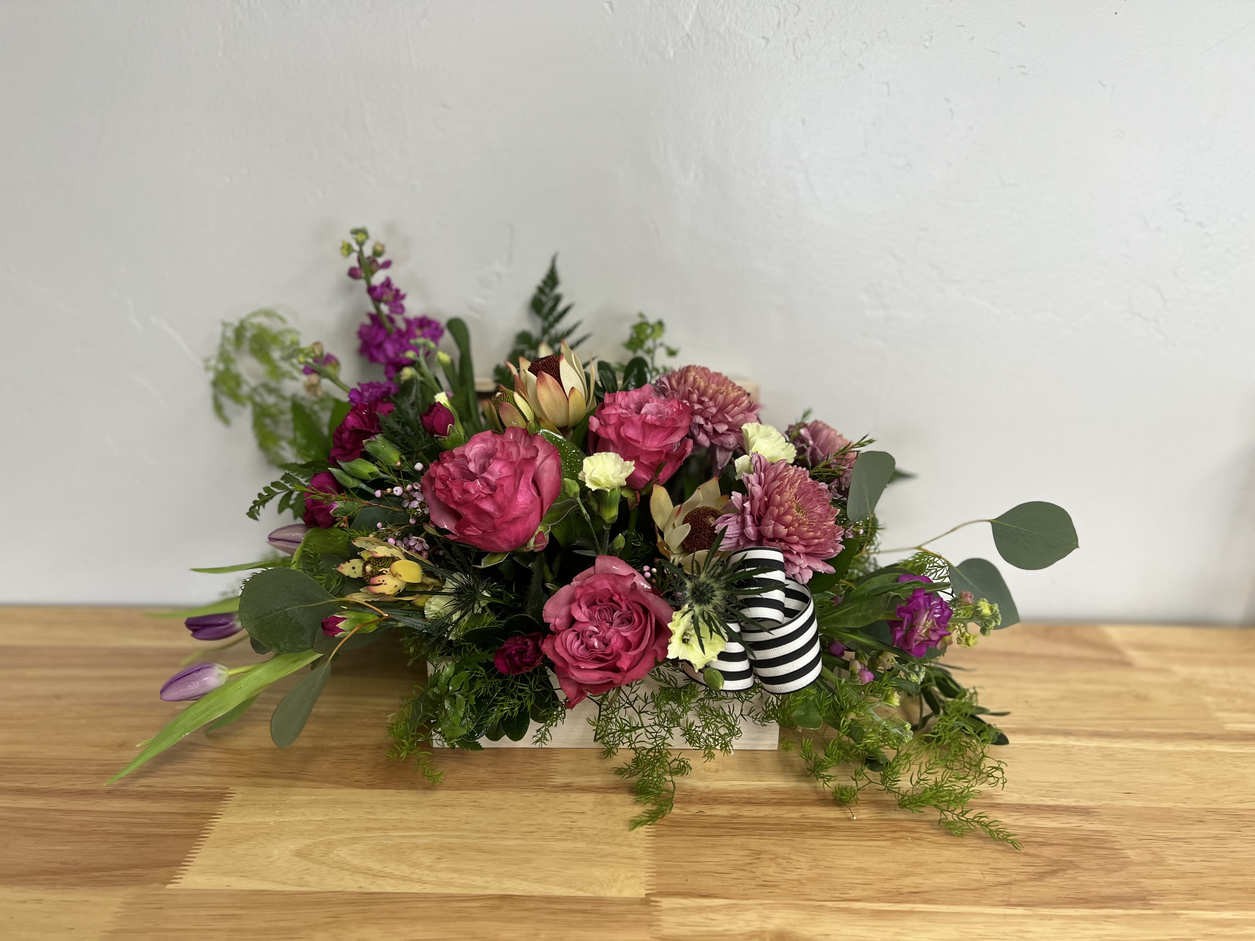 Purple Passion -  Purple Passion Arrangement  For those of us who can’t resist the beauty of purple, this design is a dream come true. Bursting with fun, vibrant tones and premium seasonal florals, it’s the ultimate celebration of all things purply and beautiful. Perfect as a gift for your favorite purple-loving friend—or as a treat for yourself—this arrangement is playful, stylish, and completely unforgettable. A true statement piece in shades of purple. 