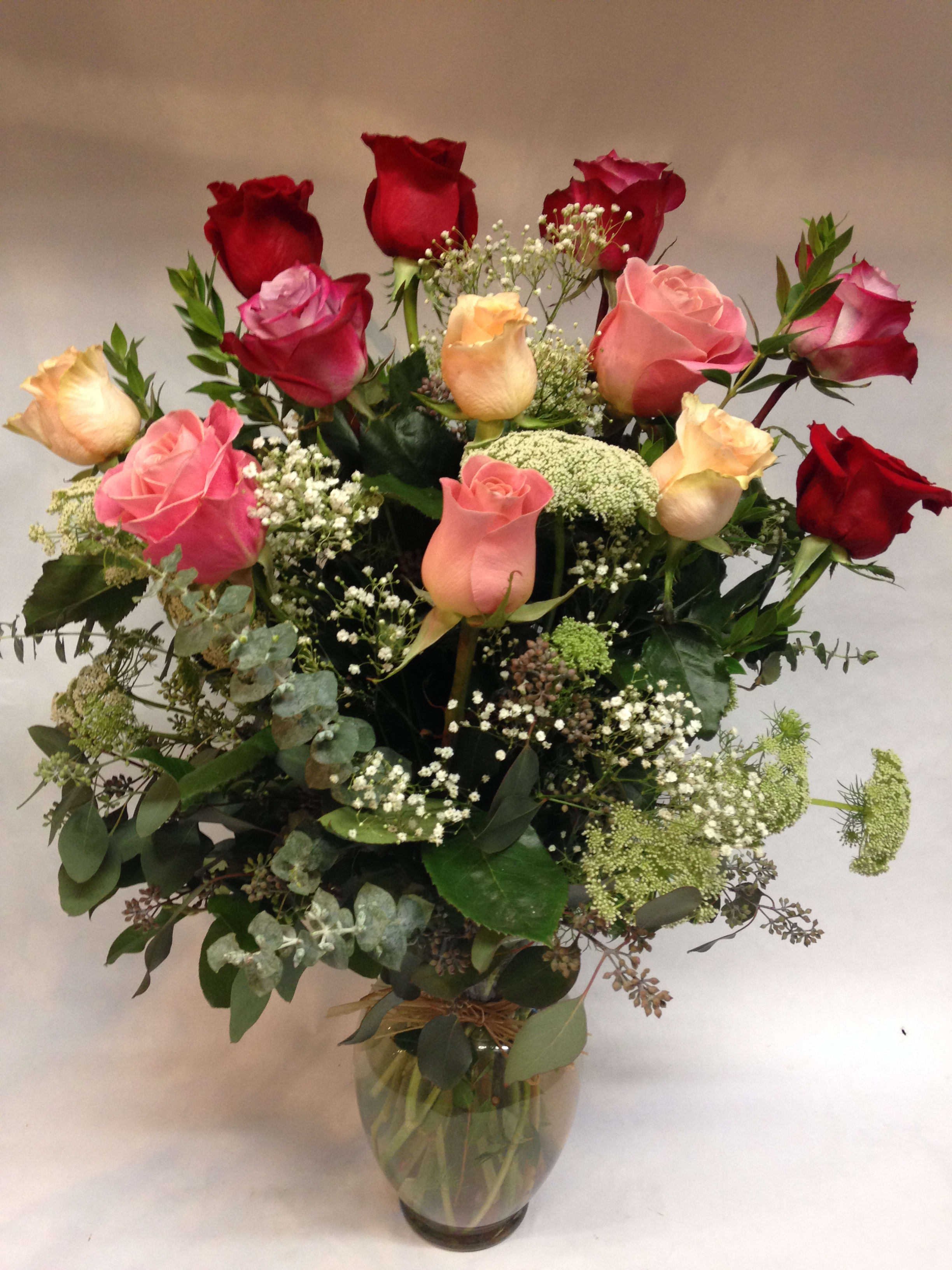 Lush Rose Garden - This large rose arrangement comes complete with various colors of premium, long stem roses, babies breath, as well as an array of lush greenery. WE also offer: peach, pink, white, orange, yellow and hot pink.     (Some flowers may be subject to change depending on the season. We will contact you with available flower substitutions; please contact us with specific questions if you are concerned with flower availability, thanks!)  Featured arrangement: $155.00 - 12 roses (Regular Price); 24 roses $255.00 (Deluxe Price);  36 roses with greenery, babies breath and vase - $355.00 (Premium Price).
