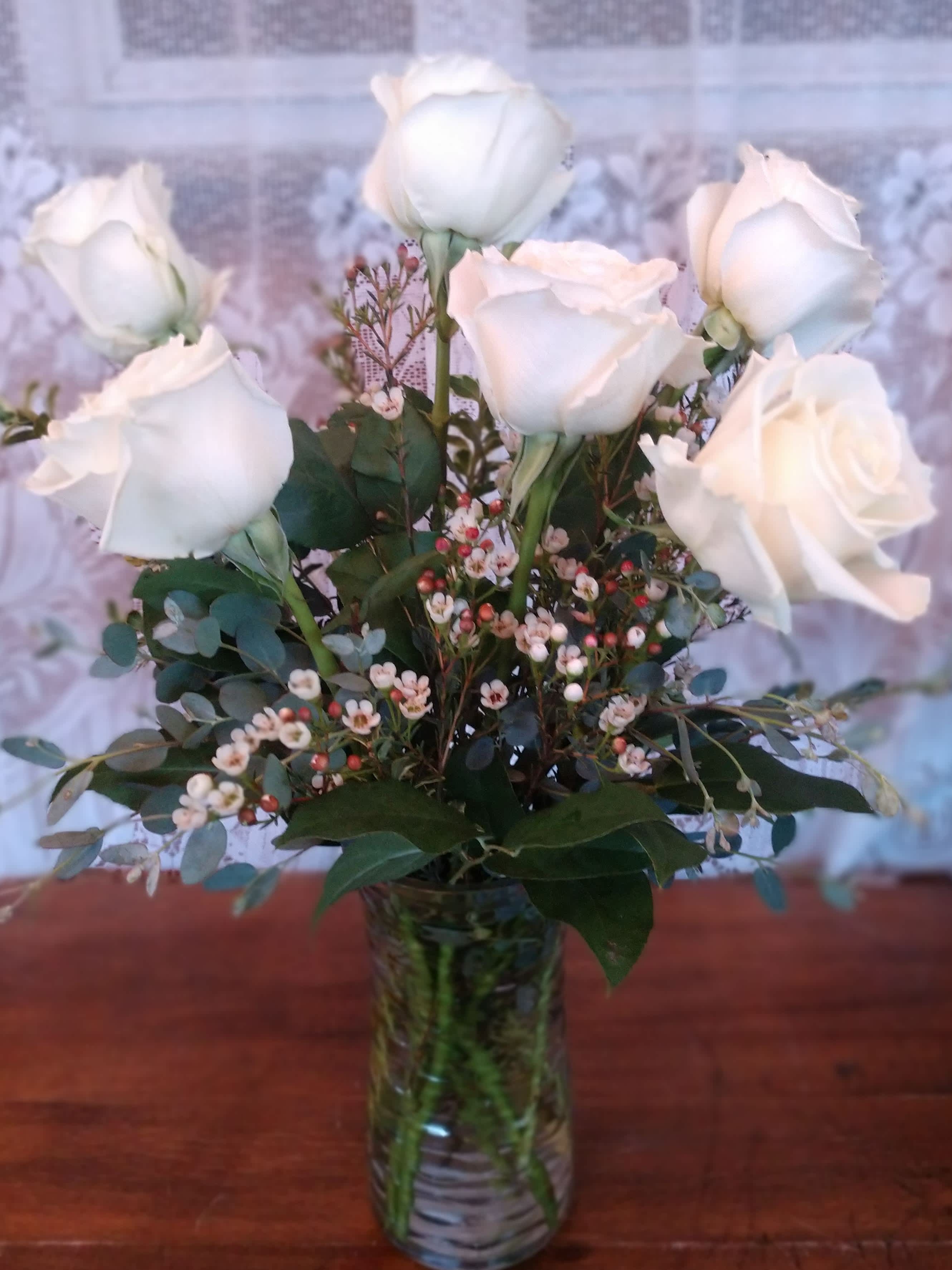Pure - Premium white roses arranged in a glass vase. 