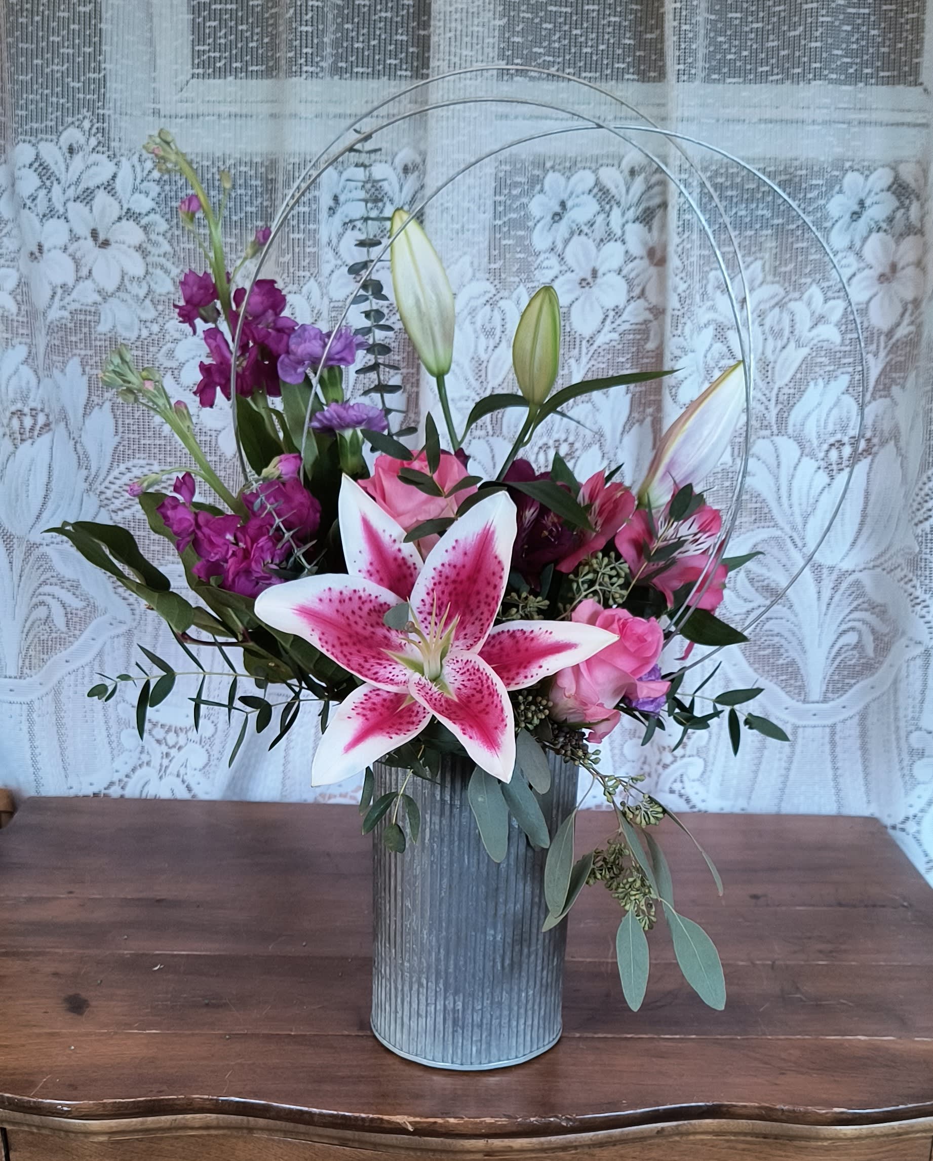 Blushing - A trendy design of garden flowers to include stock, lily, roses and alstroemeria but not limited to. Colors may vary from picture.