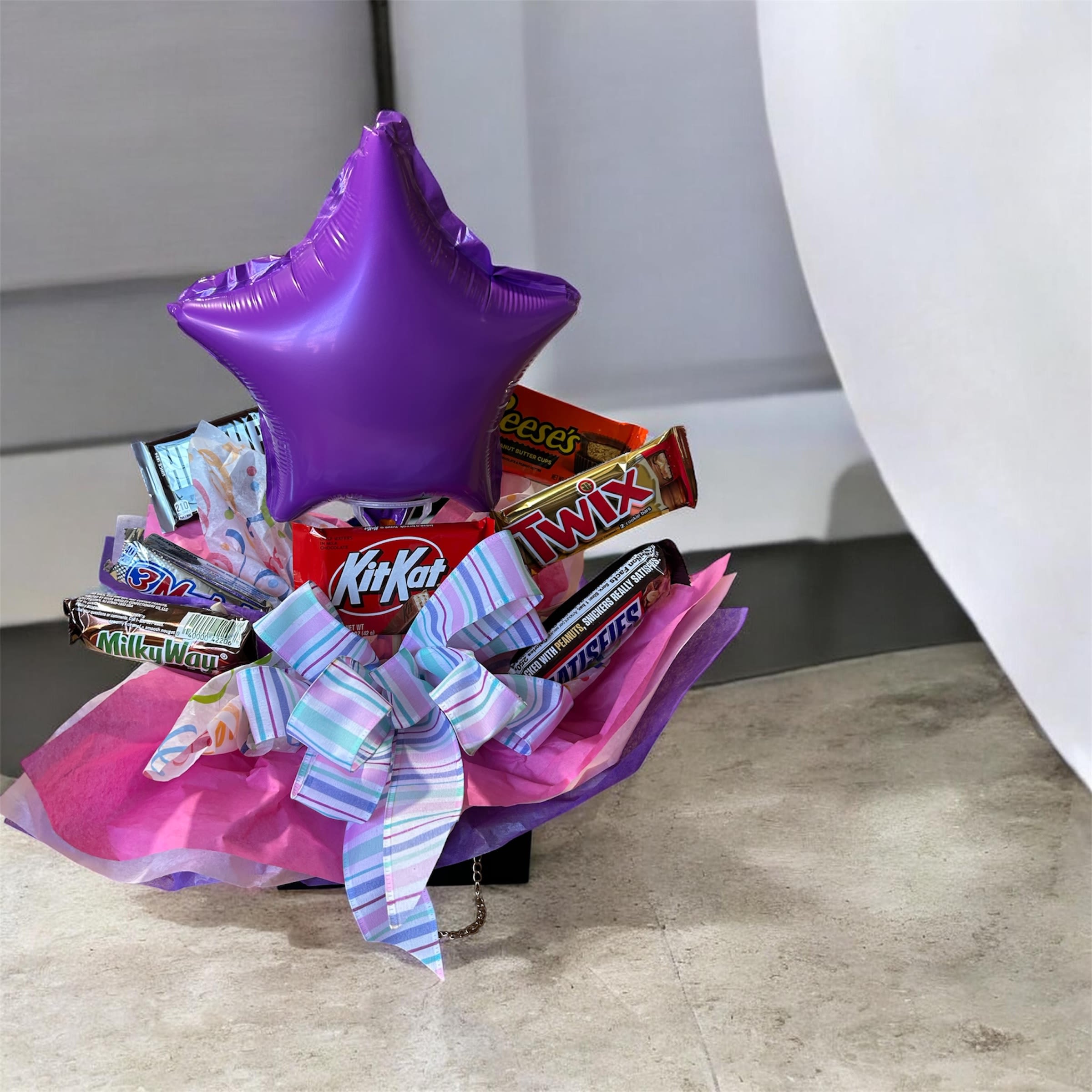 Candy Arrangement in  Purse - Assorted chocolate candies in a purse container with small balloon.
