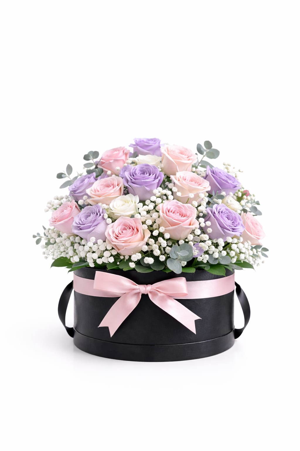 Pastel Garden Rose Hatbox – Short - This graceful floral design features 18 roses in blush, lavender, and ivory hues, beautifully arranged with white accents and fresh greenery in a short black hatbox. Soft, timeless, and thoughtfully crafted.  Better For: Mother’s Day, Women’s Day, Birthday, Get Well, Just Because.  Each piece is Designer’s Choice, created with fresh seasonal blooms. Flowers and colors may vary based on availability while maintaining the overall style and quality. 