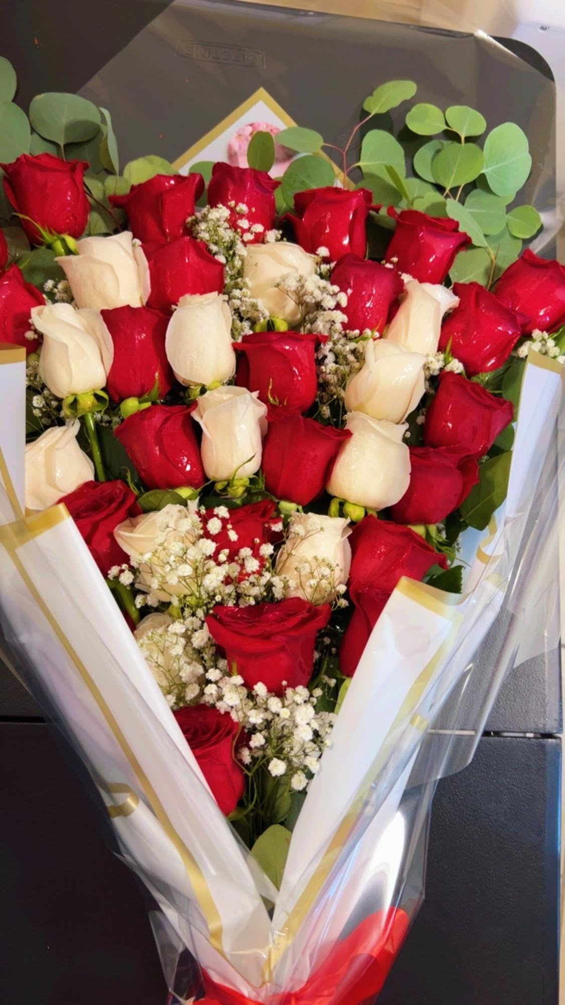 Red &amp; White Rose Layered Elegance - A breathtaking blend of passionate red roses and creamy white roses, delicately accented with baby’s breath and fresh greenery. This handcrafted bouquet symbolizes love, purity, and timeless beauty—perfect for anniversaries, romantic gestures, or meaningful celebrations. Designed to impress and leave a lasting impression. 36 count roses