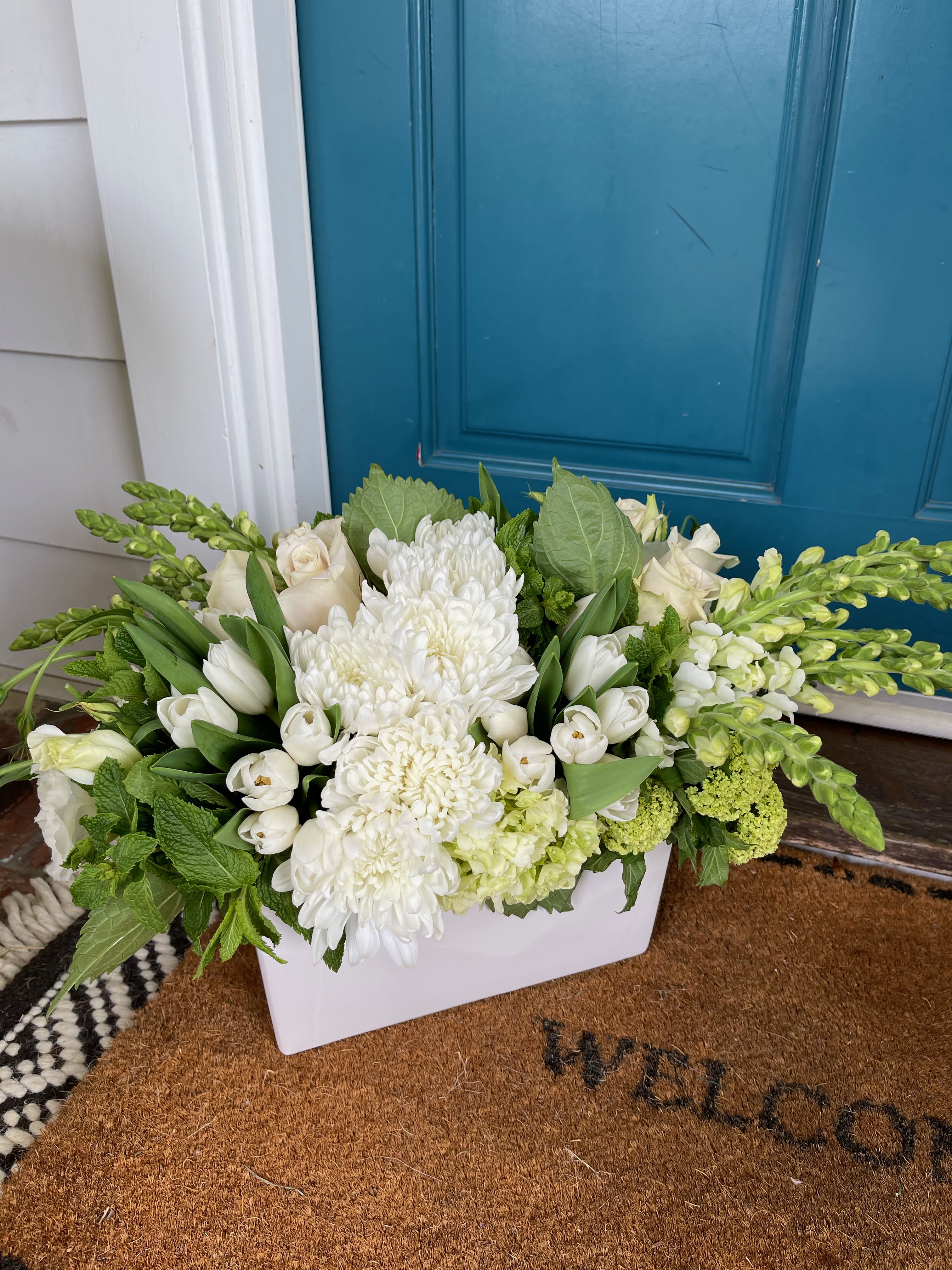 Patience - White and green blooms.  A classic, timeless mix of these two colors using top shelf blooms in season.  The seasonal bloom featured in this piece is tulips.  If not in season will be swapped out with another seasonal bloom.  A tight, pave, modern piece.  