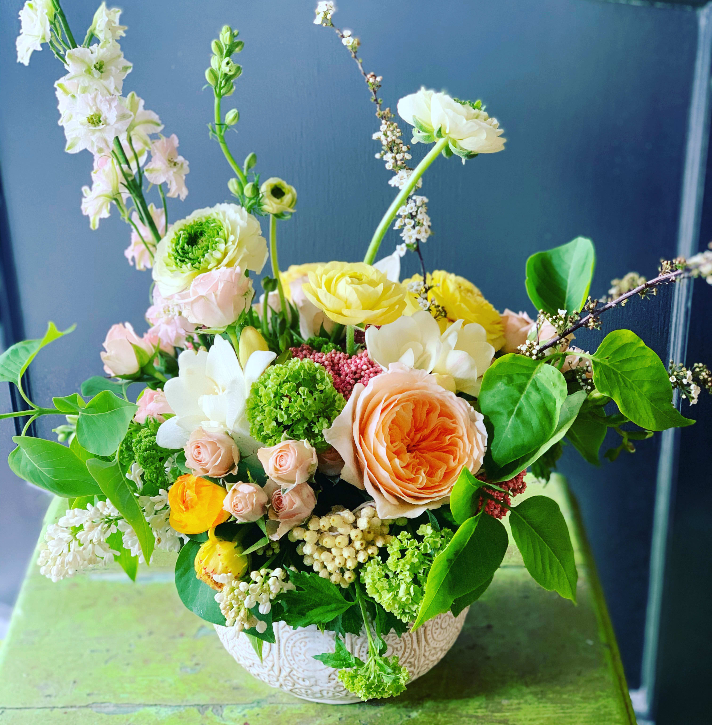 Garden Party - Clay pot with a loose and whimsical designed mixed bouquet of seasonal blooms...colors can vary on product availability