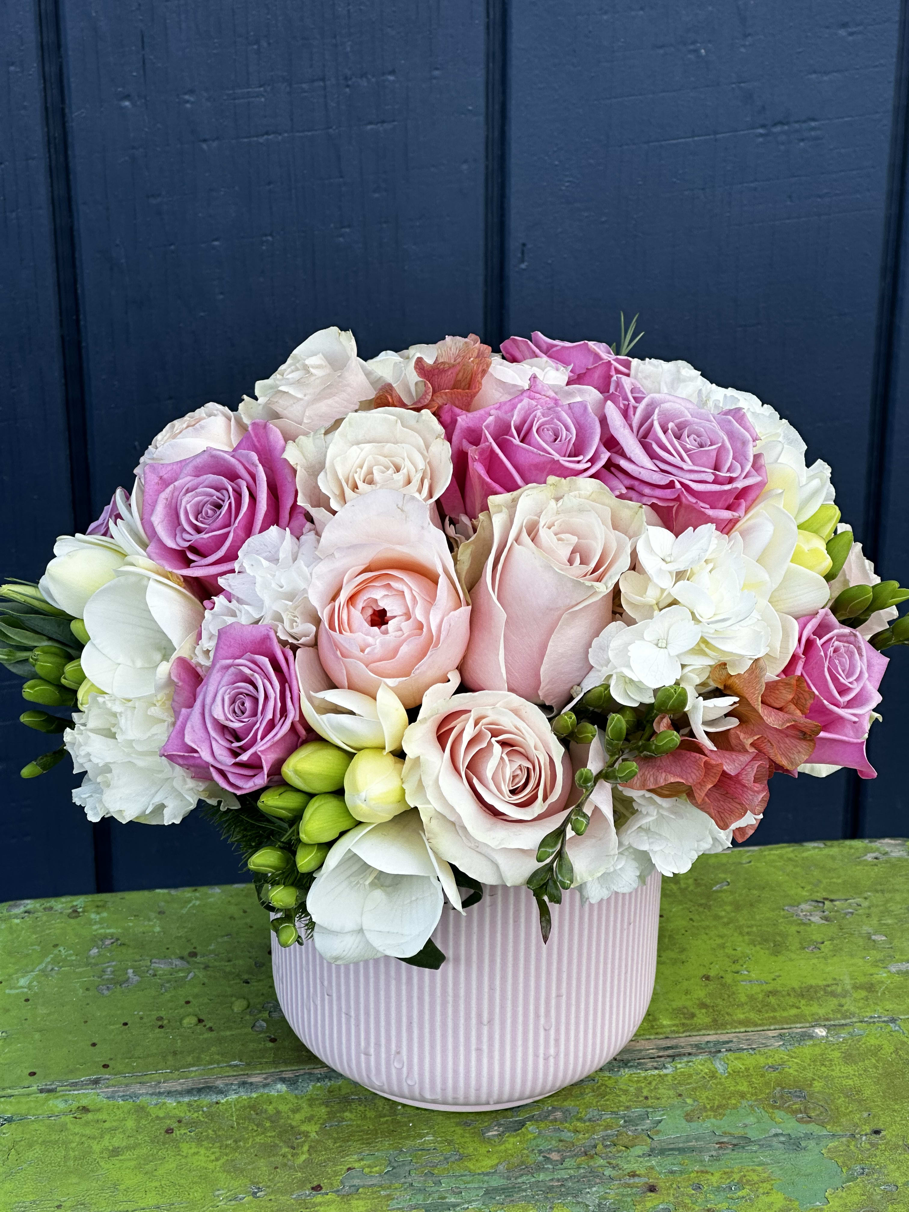 Perfectly Pink - Low profile container filled with mixed blooms …soft pink and white hues… containers may vary depending on availability 
