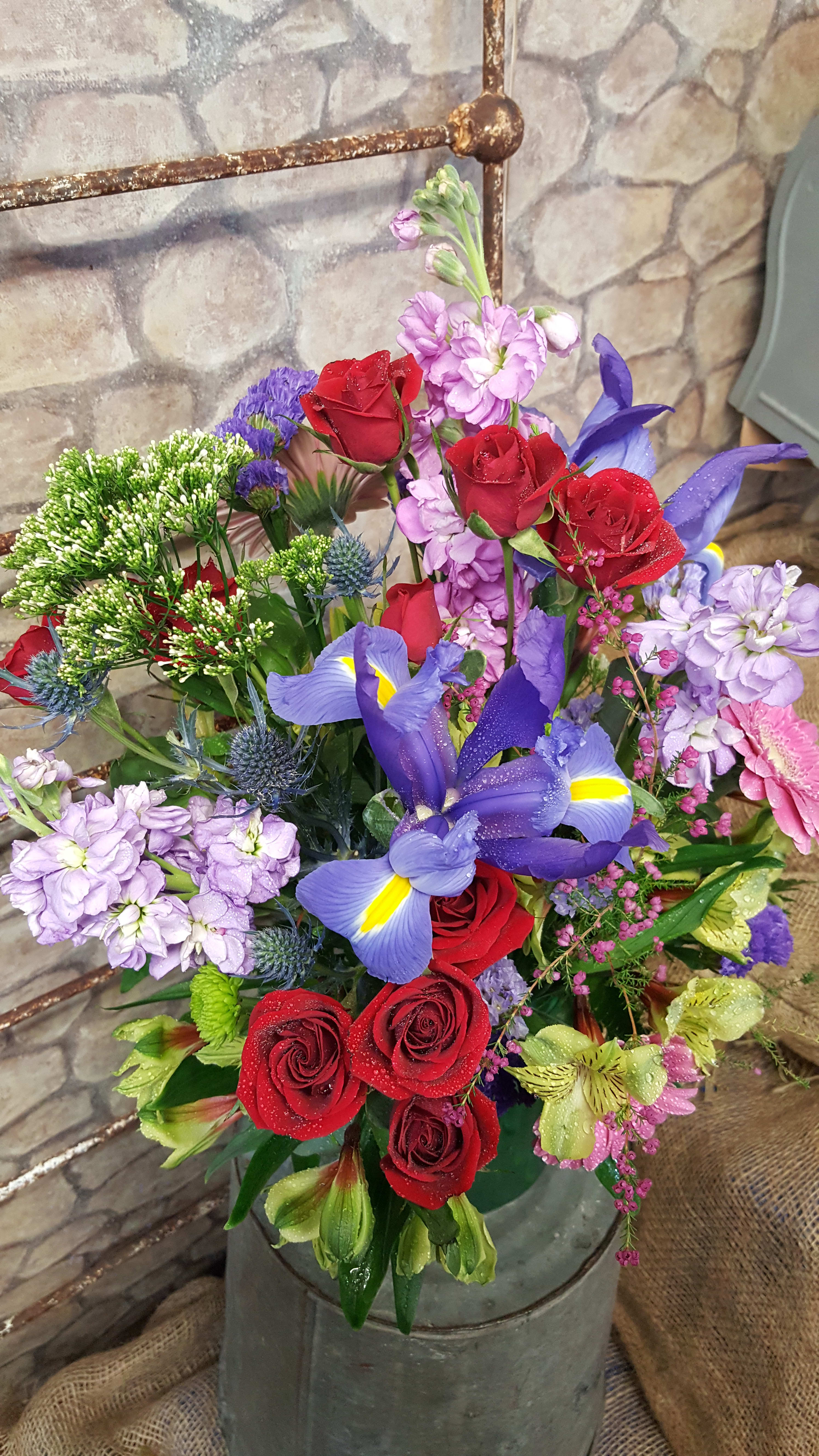  Dreamy Valentine - Designers choice of bold hues will be designed in a glass vase or ceramic container. The photo is a sampling of bold flower colors....the bloom choices &amp; container WILL vary at times. Iris will be in the design! Based on market fresh inventory at time or order &amp; delivery date. 