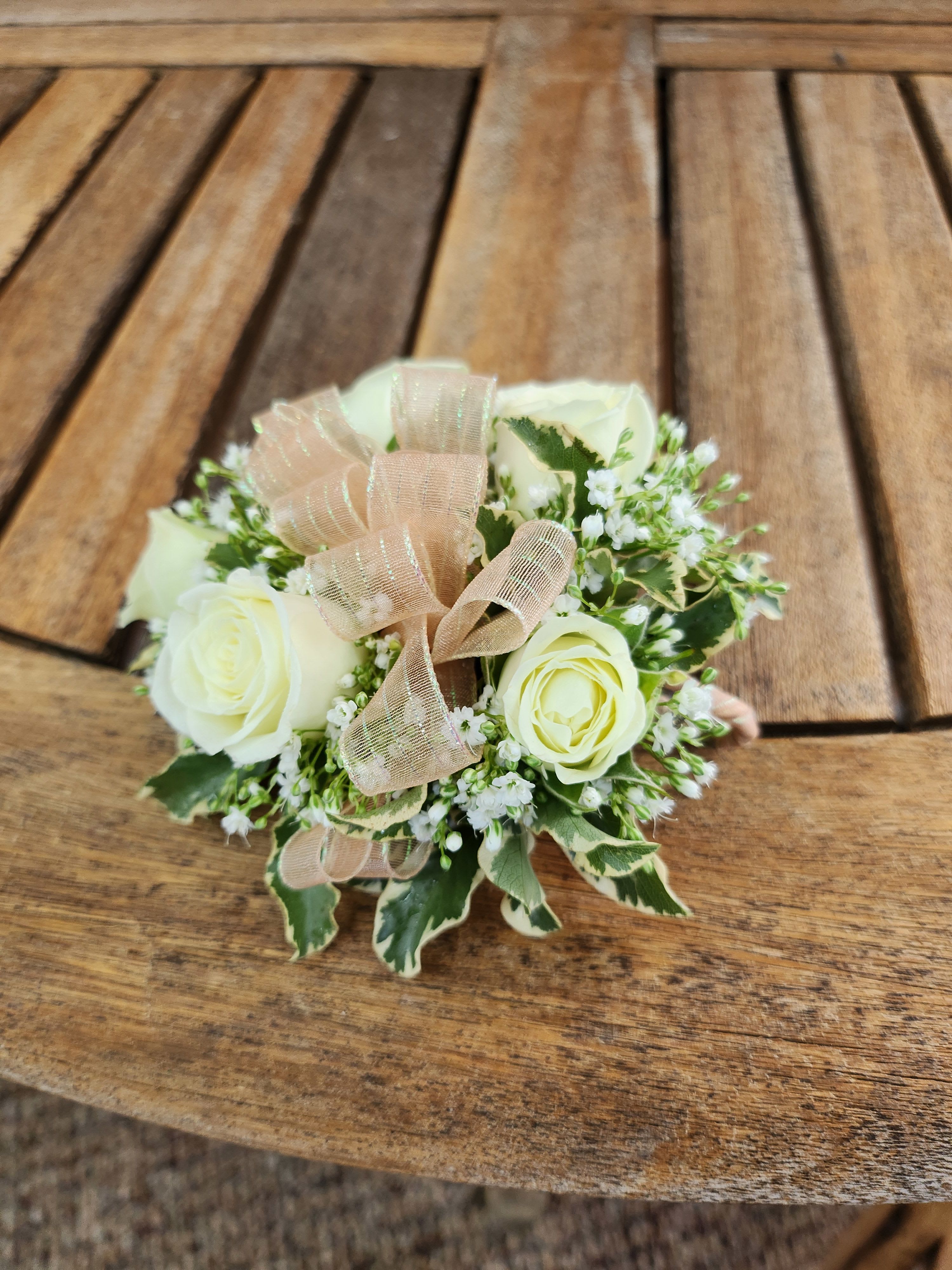 Wrist Corsage With White Spray Roses And Peach Ribbon - Wrist Corsage With white spray roses, greenery, filler flower and peach ribbon.
