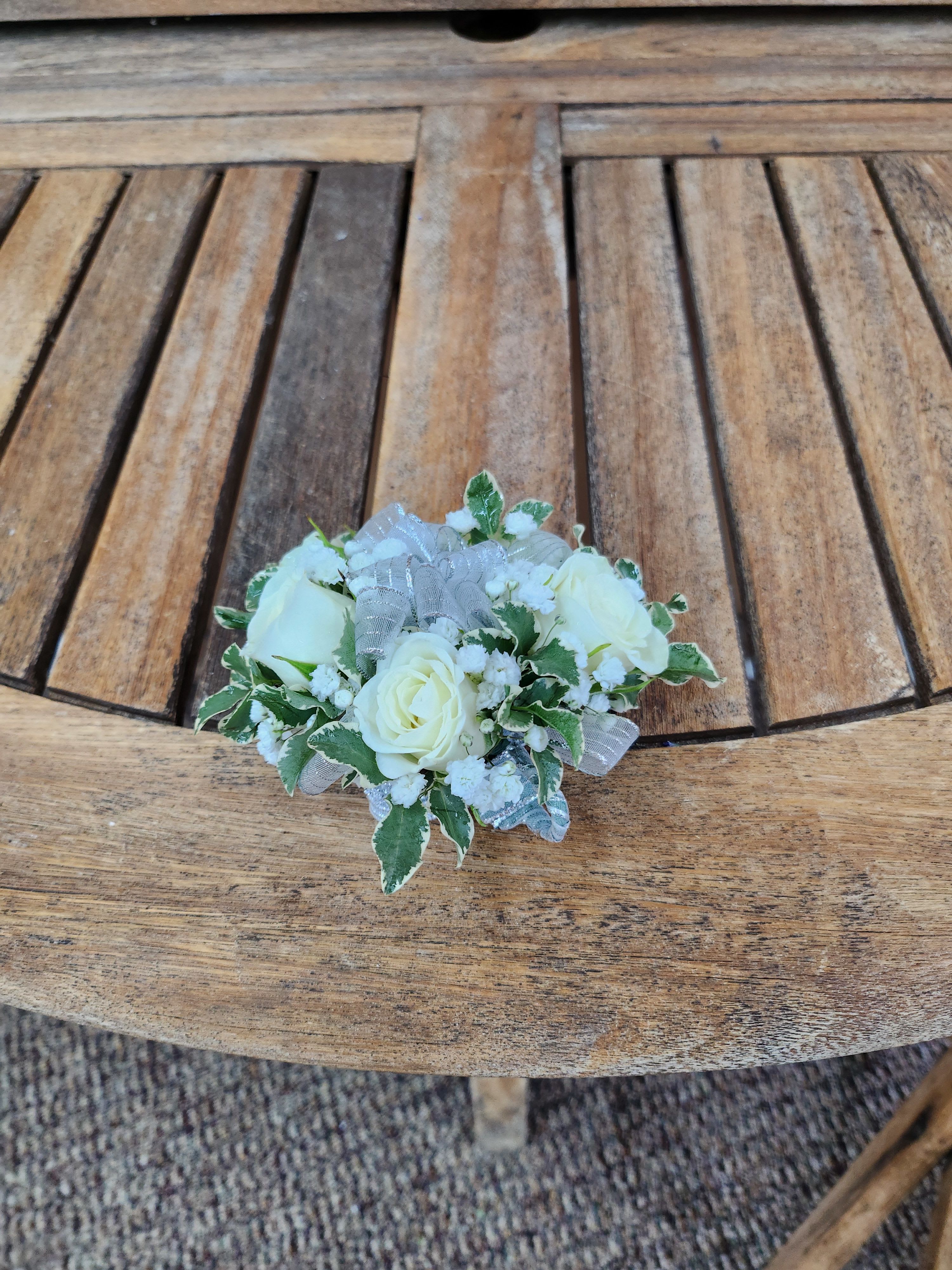Wrist Corsage With White Spray Rose And Silver Ribbon - Wrist Corsage with white spray roses, greenery, filler, and silver Ribbon