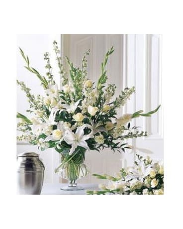 Traditional Victorian Bouquet - White lilies burst forth in this classy and sophisticated bouquet. Appropriate for the home or funeral home. Arrangemement is made a white funeral urn.   FCS35-3182