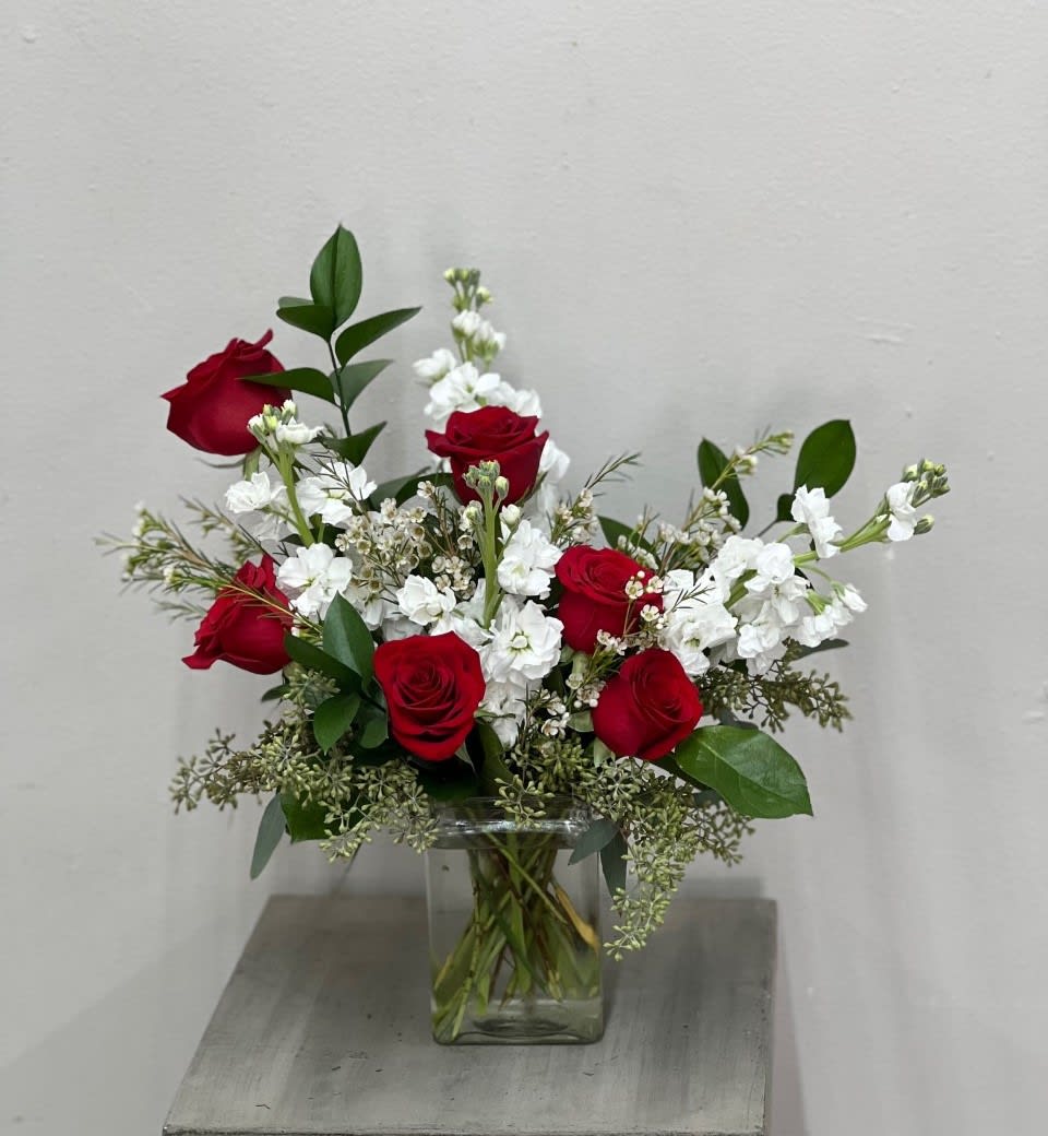 My Crush - Surprise your crush with this beautiful arrangement of Red Roses with fragrant white stock, white wax flower and seeded eucalyptus in a clear vase.   STANDARD - 6 Roses DELUXE - 12 Roses